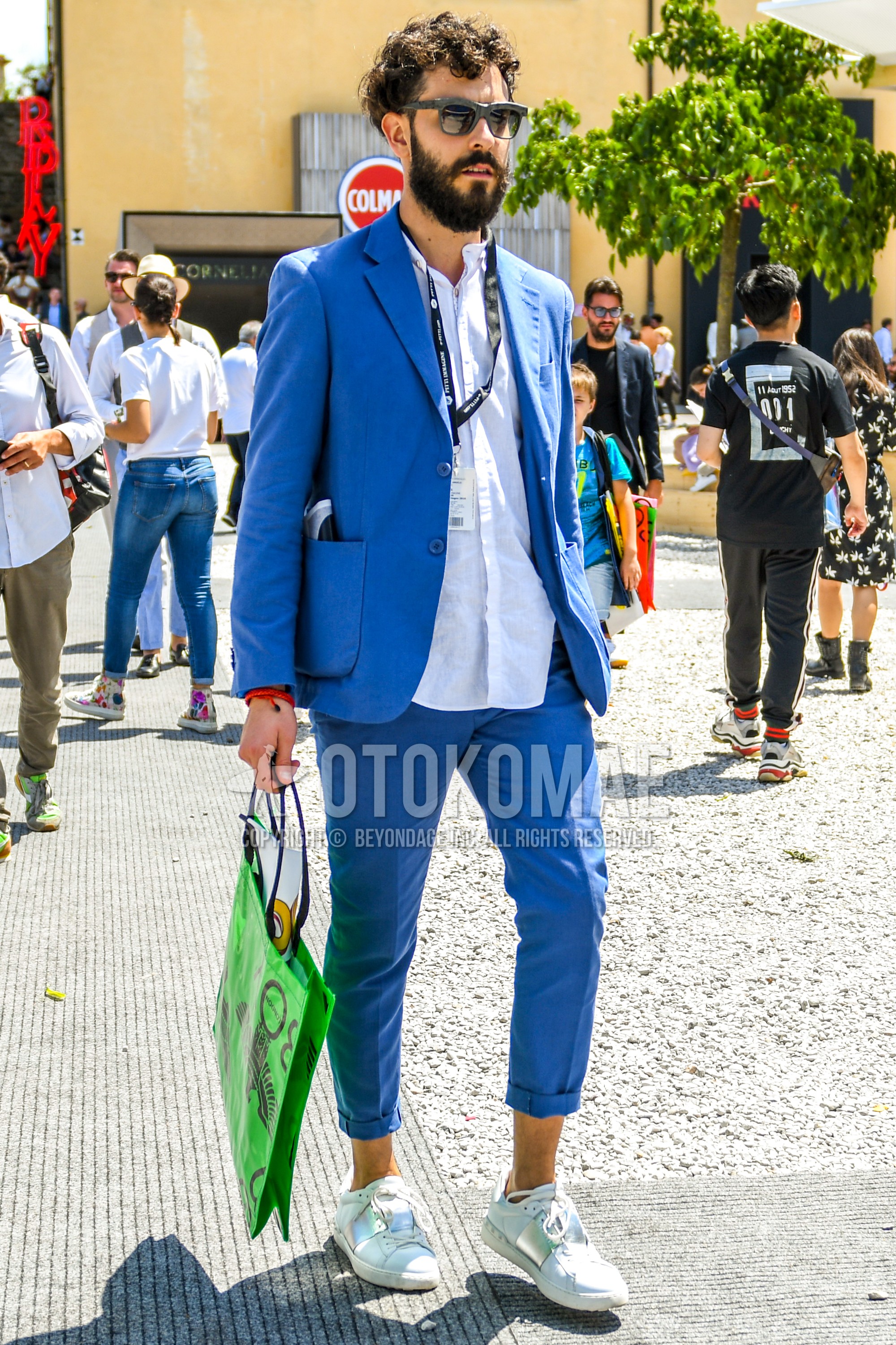 Men's spring summer autumn outfit with plain sunglasses, white plain shirt, white sneakers, light blue plain suit.