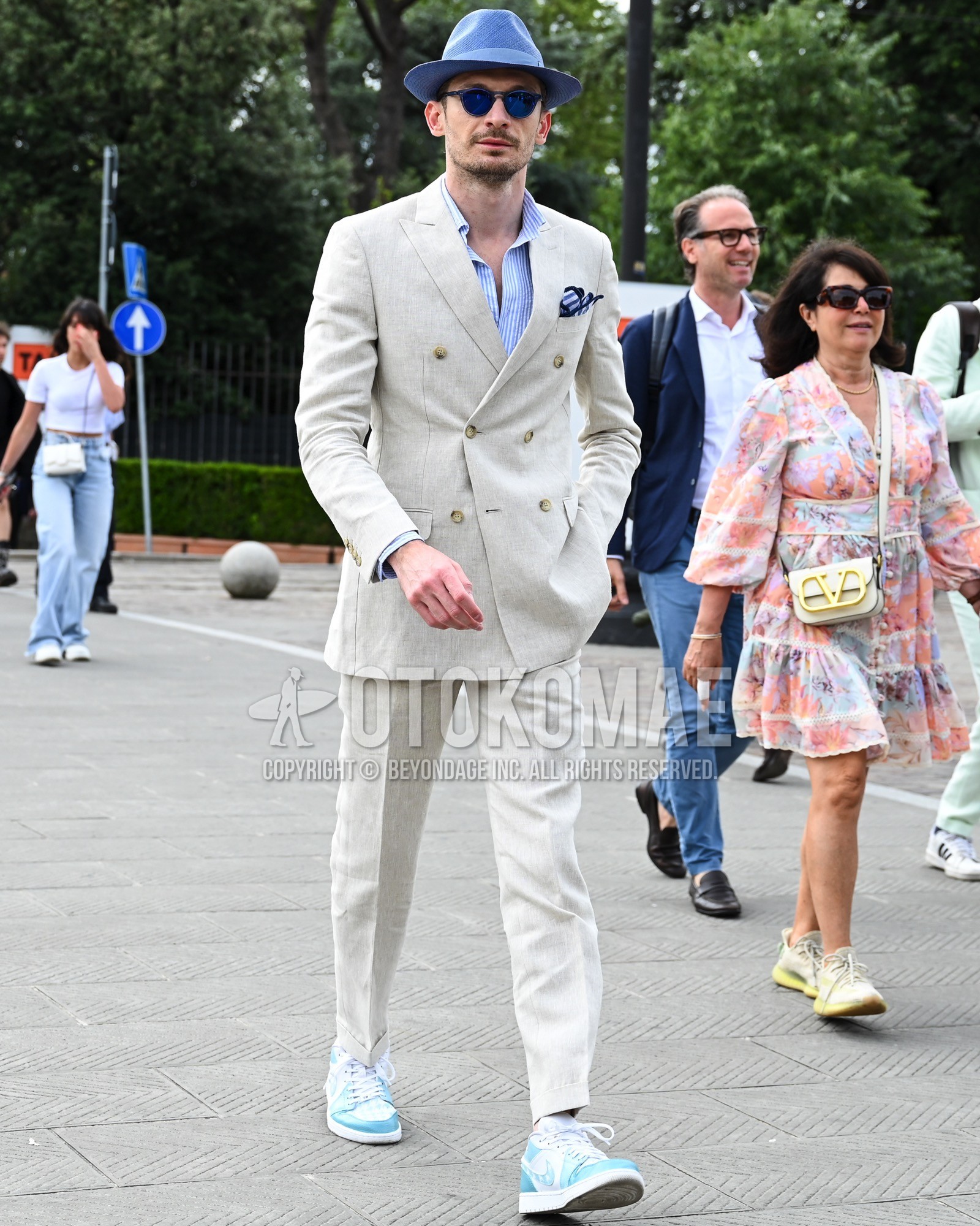 Men's spring summer autumn outfit with light blue plain hat, light blue plain shirt, light blue low-cut sneakers, white plain suit.