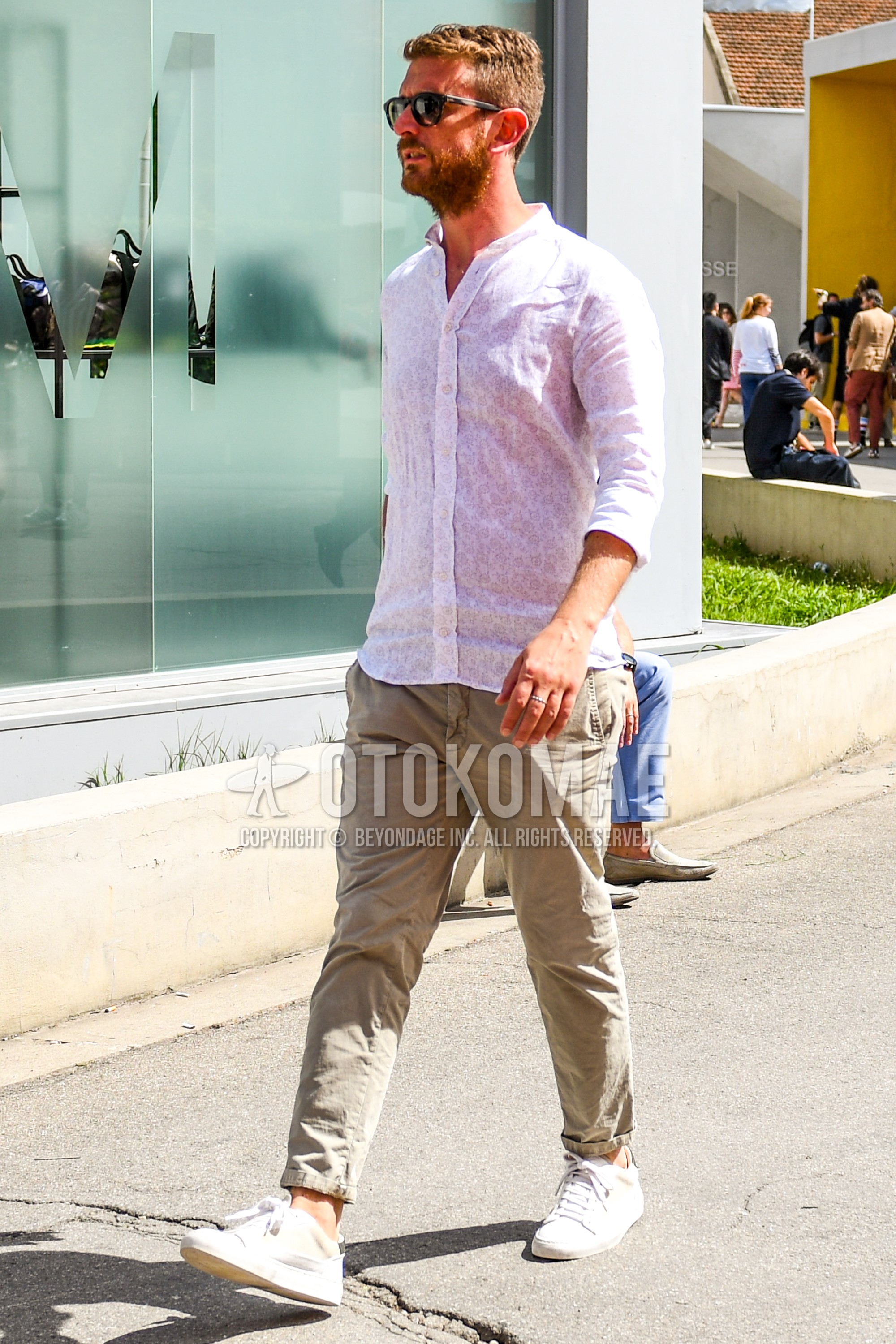 Men's spring summer outfit with plain sunglasses, white tops/innerwear shirt, beige plain chinos, white low-cut sneakers.