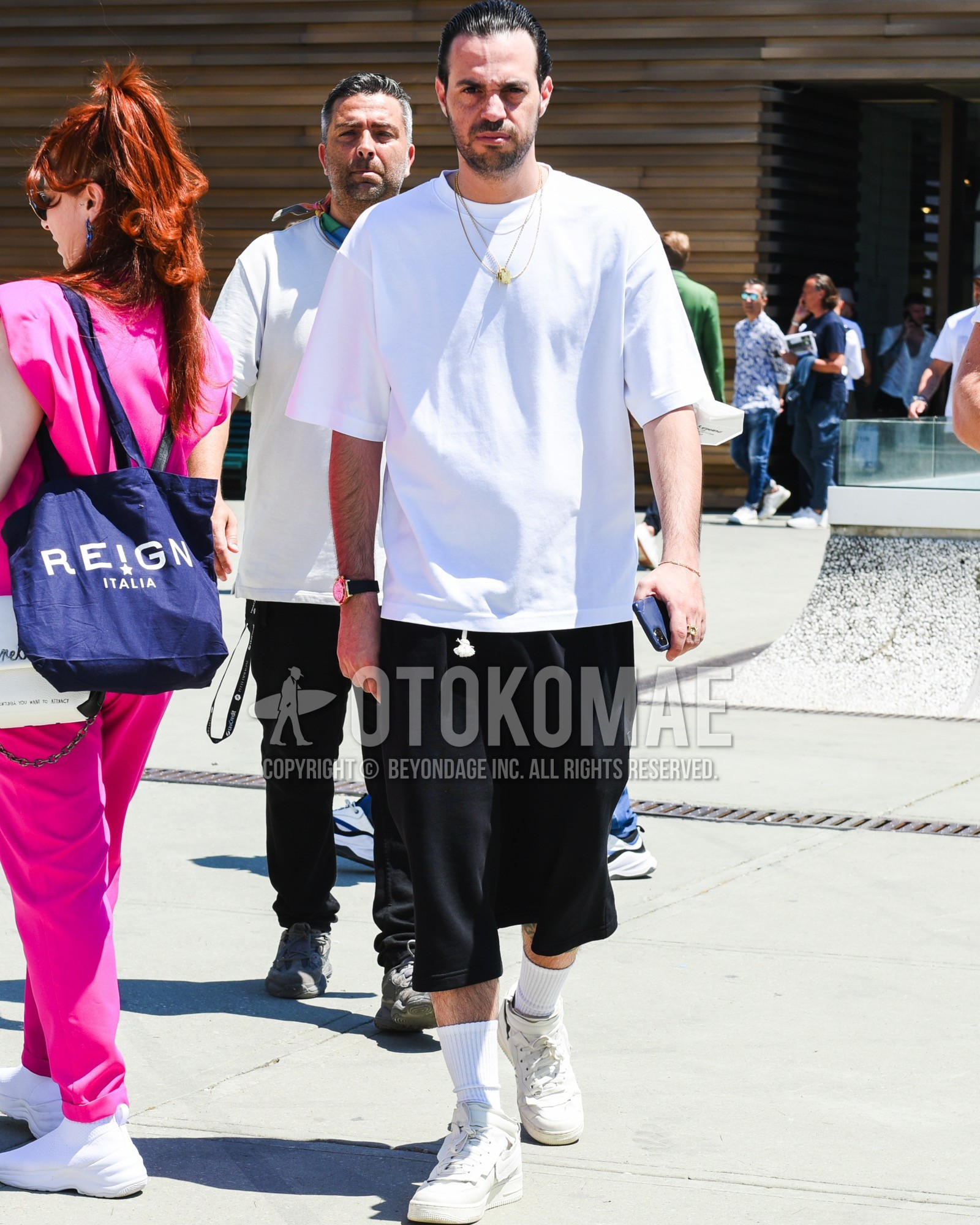 Men's spring summer outfit with white plain t-shirt, black plain short pants, white plain socks, white high-cut sneakers.