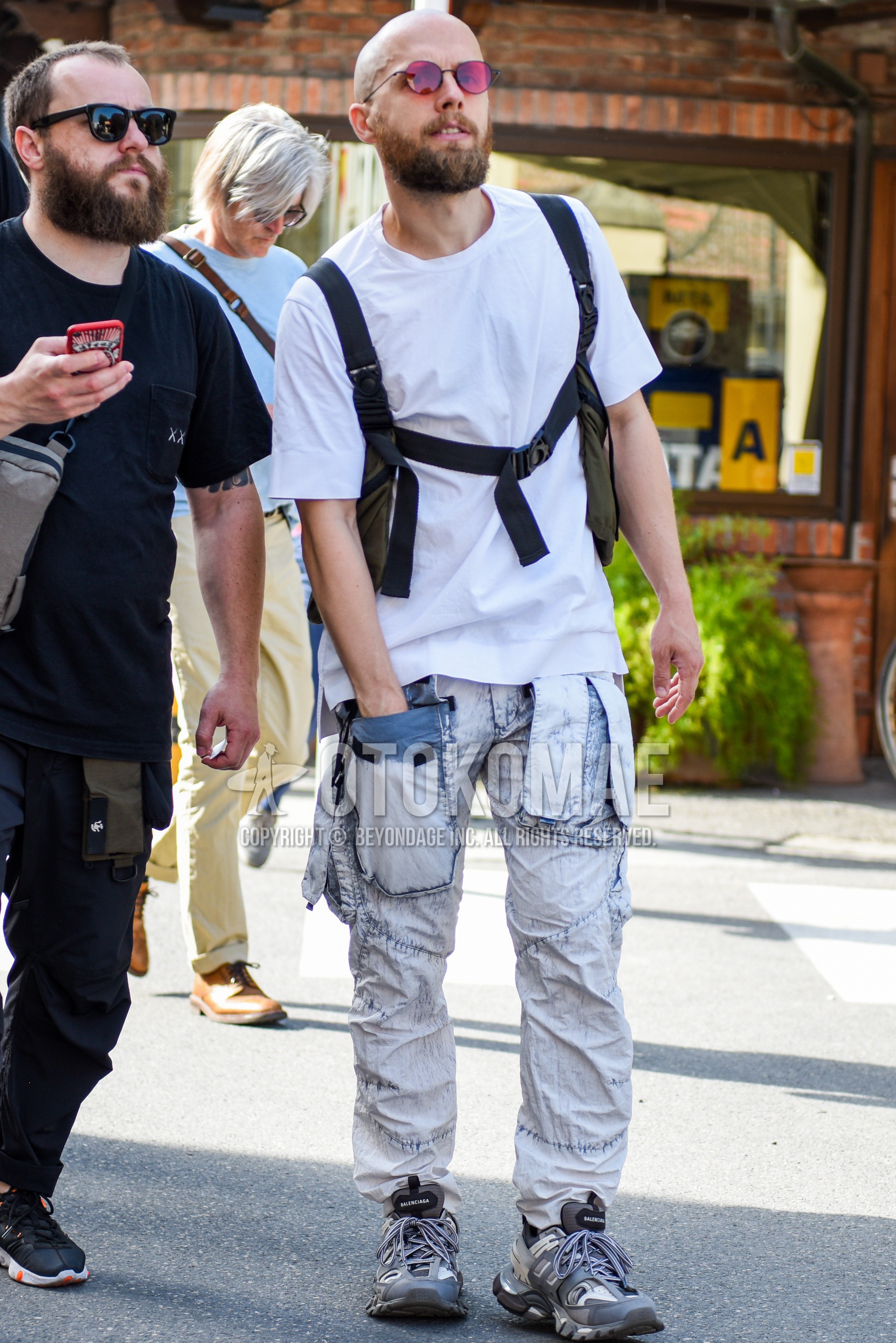Men's summer outfit with white plain t-shirt, white plain cotton pants, gray low-cut sneakers.
