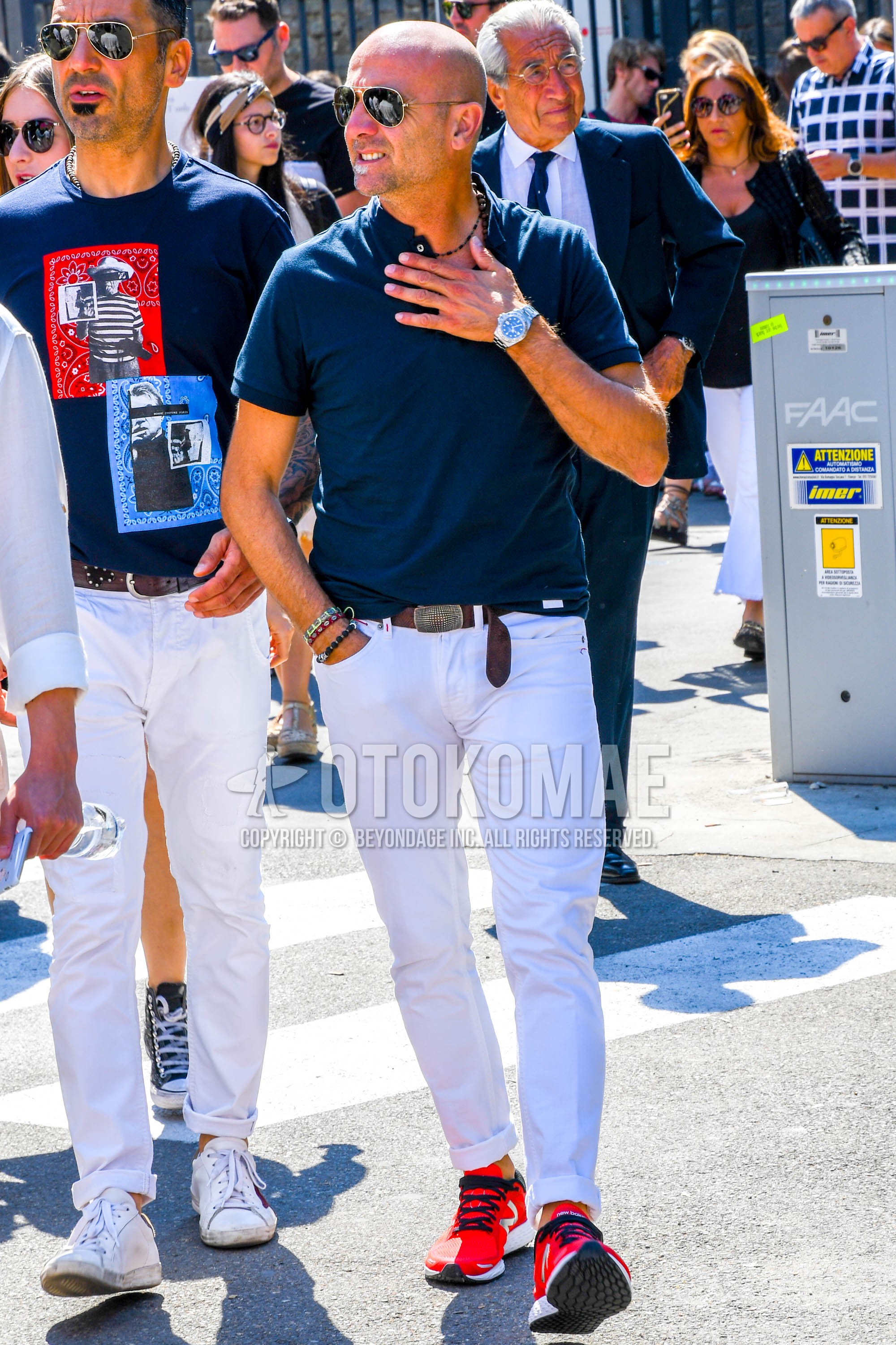 Men's summer outfit with plain sunglasses, navy plain t-shirt, brown plain leather belt, white plain denim/jeans, red low-cut sneakers.