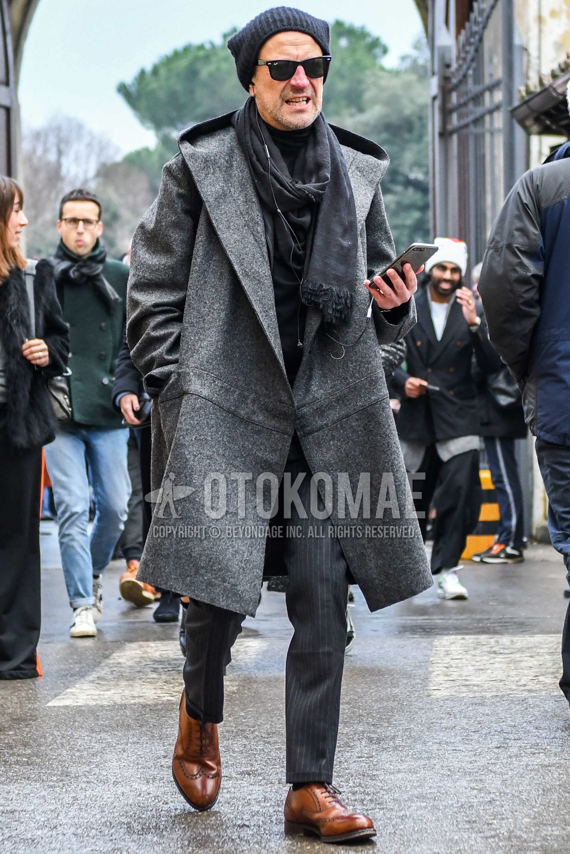 Men's winter outfit with black plain knit cap, plain sunglasses, dark gray plain scarf, gray plain hooded coat, black plain turtleneck knit, gray stripes slacks, brown wing-tip shoes leather shoes.