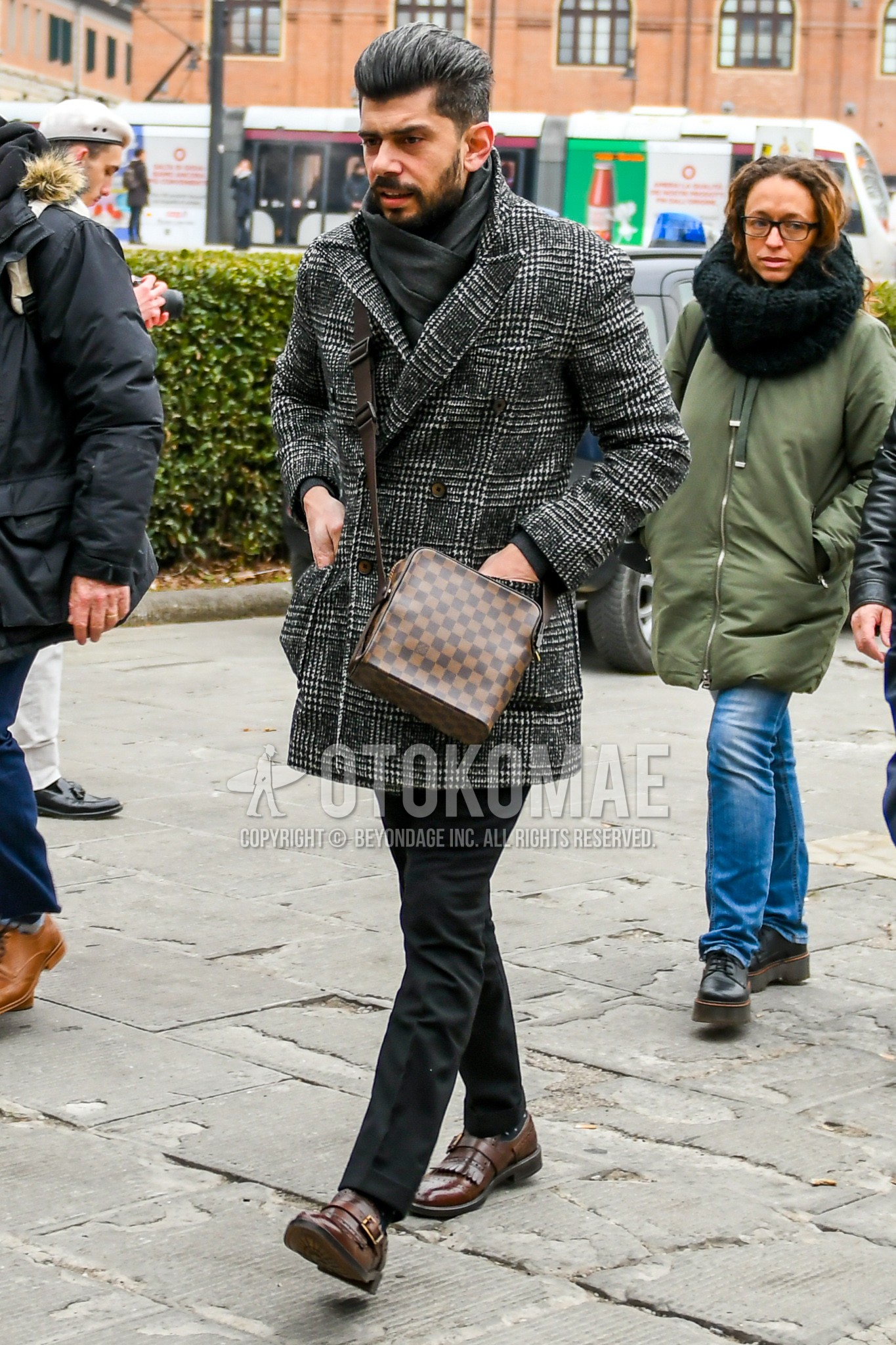 Men's autumn winter outfit with gray plain scarf, gray check chester coat, dark gray plain slacks, black dots socks, brown monk shoes leather shoes, brown check shoulder bag.