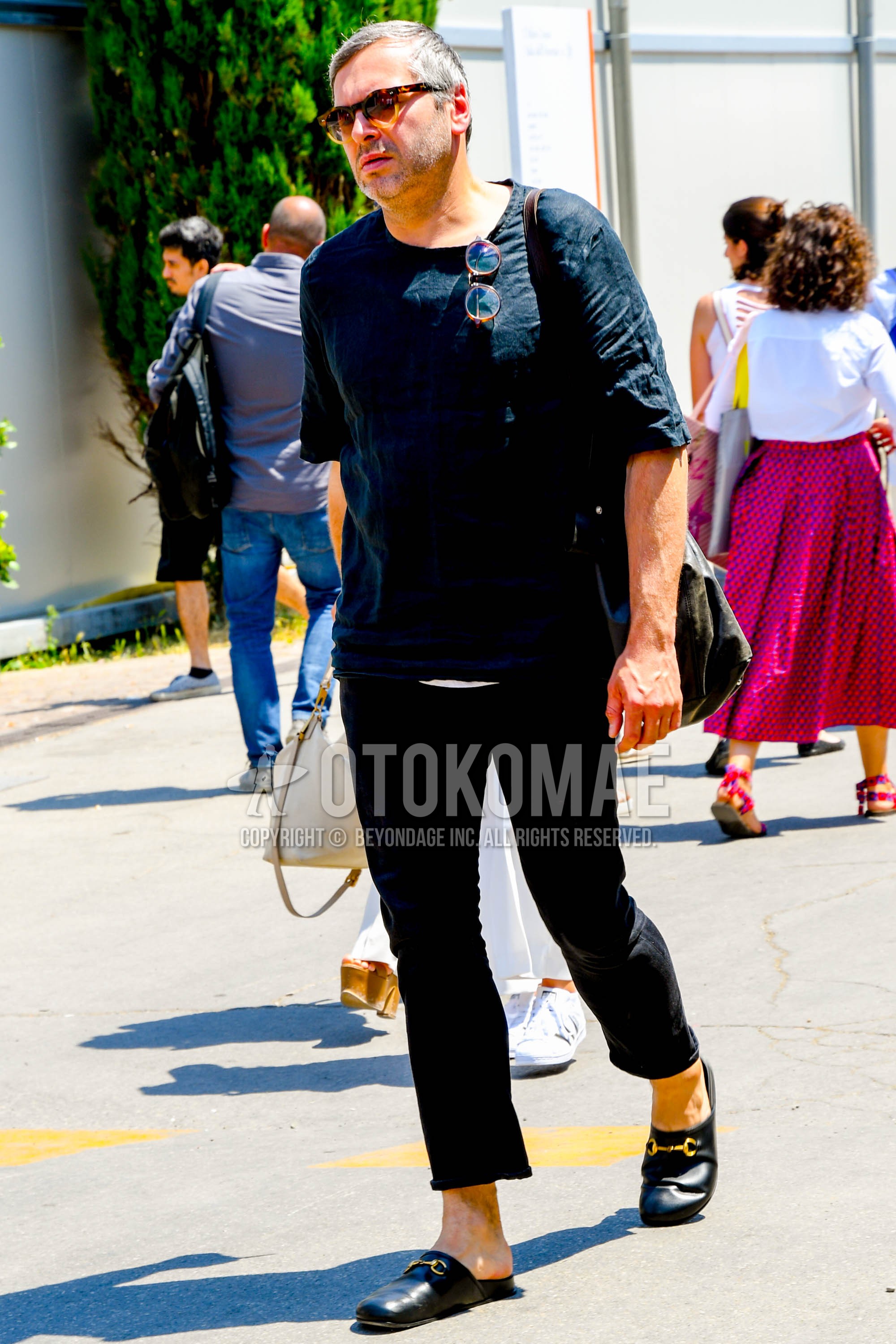 Men's summer outfit with plain sunglasses, black plain t-shirt, black plain ankle pants, black leather sandals.