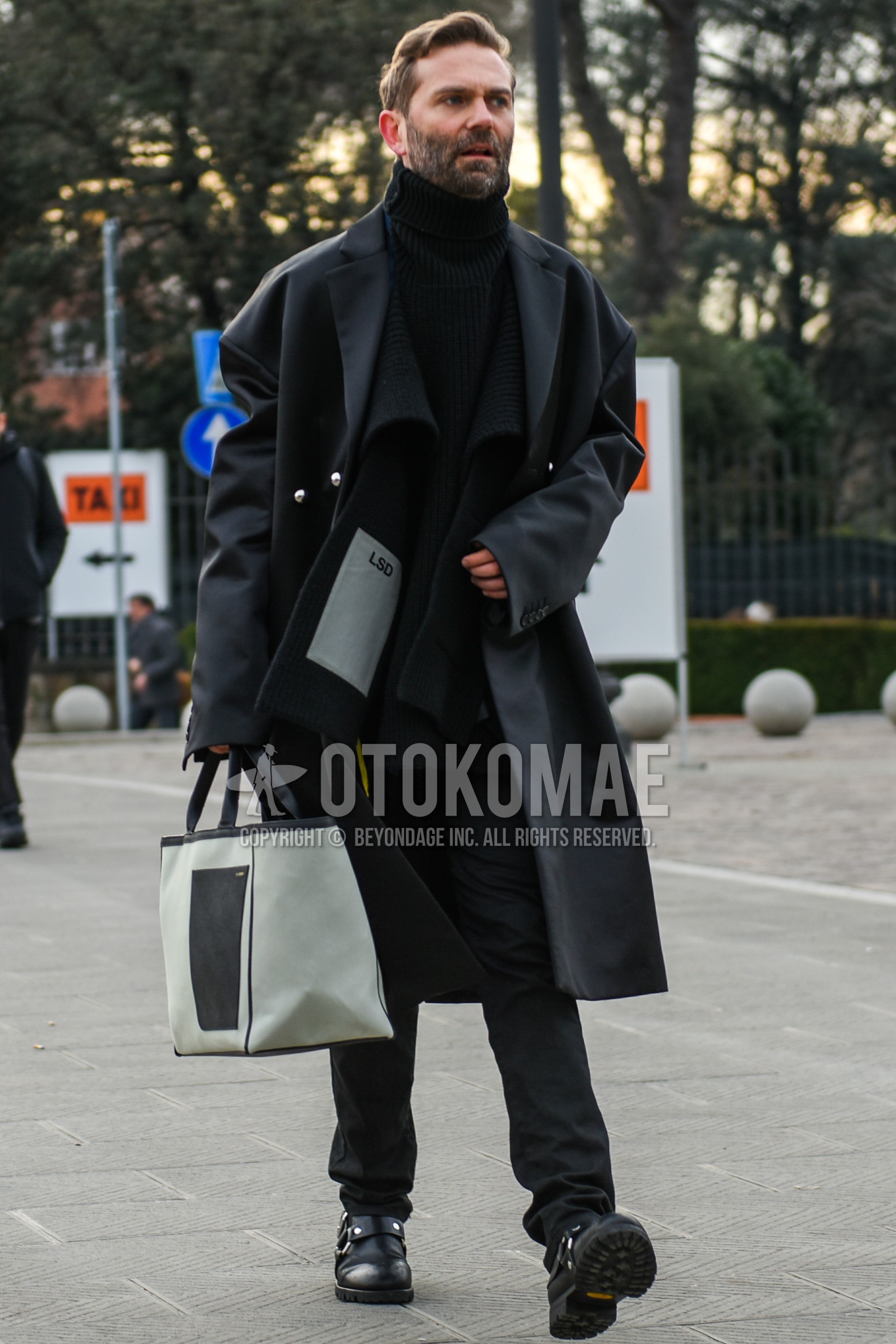 Men's autumn winter outfit with dark gray plain chester coat, black plain turtleneck knit, black plain slacks, black  boots, beige plain briefcase/handbag.