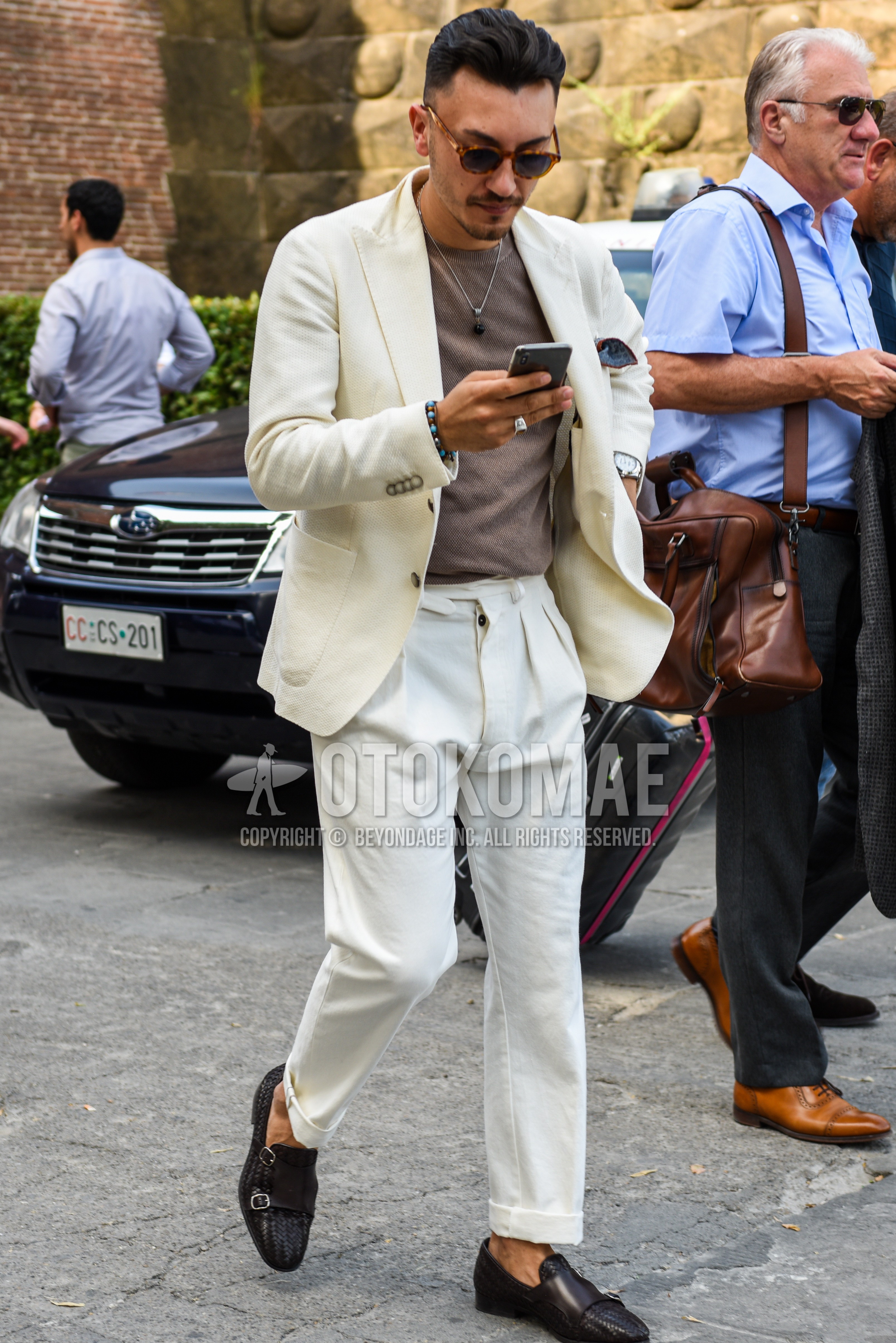 Men's spring summer autumn outfit with brown tortoiseshell sunglasses, white plain tailored jacket, brown plain t-shirt, white plain beltless pants, brown monk shoes leather shoes.
