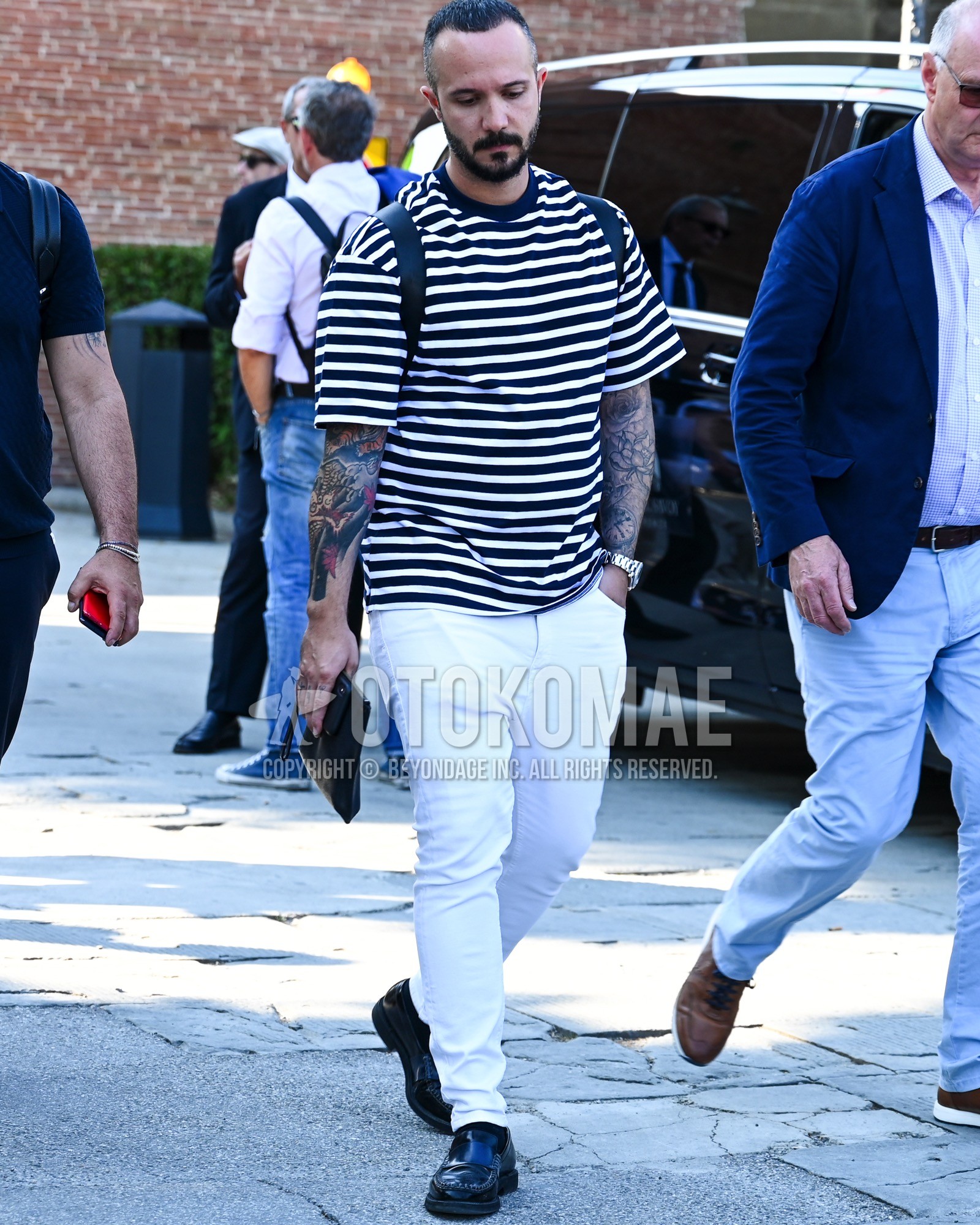 Men's spring summer outfit with navy white horizontal stripes t-shirt, white plain denim/jeans, black monk shoes leather shoes, black plain backpack.