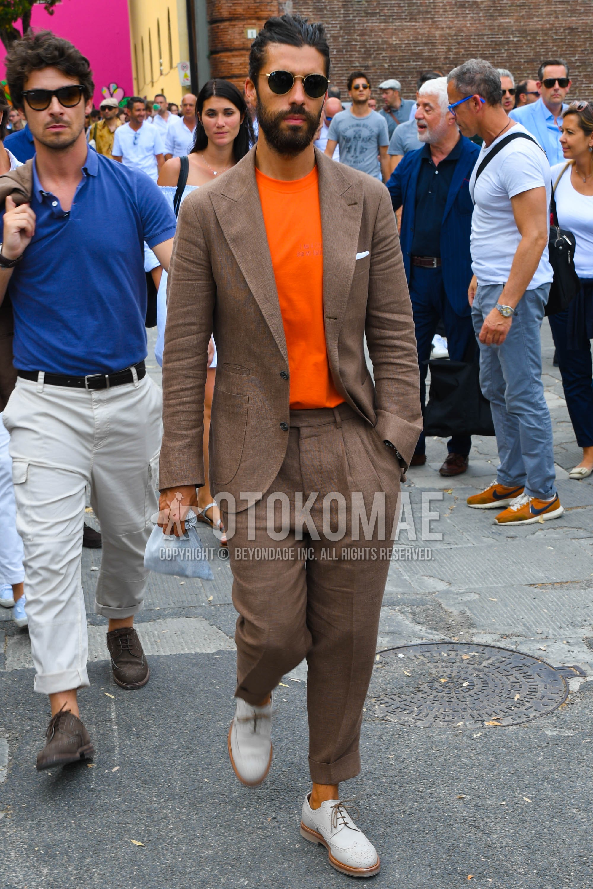 Men's spring summer autumn outfit with plain sunglasses, orange plain t-shirt, white brogue shoes leather shoes, brown plain suit.