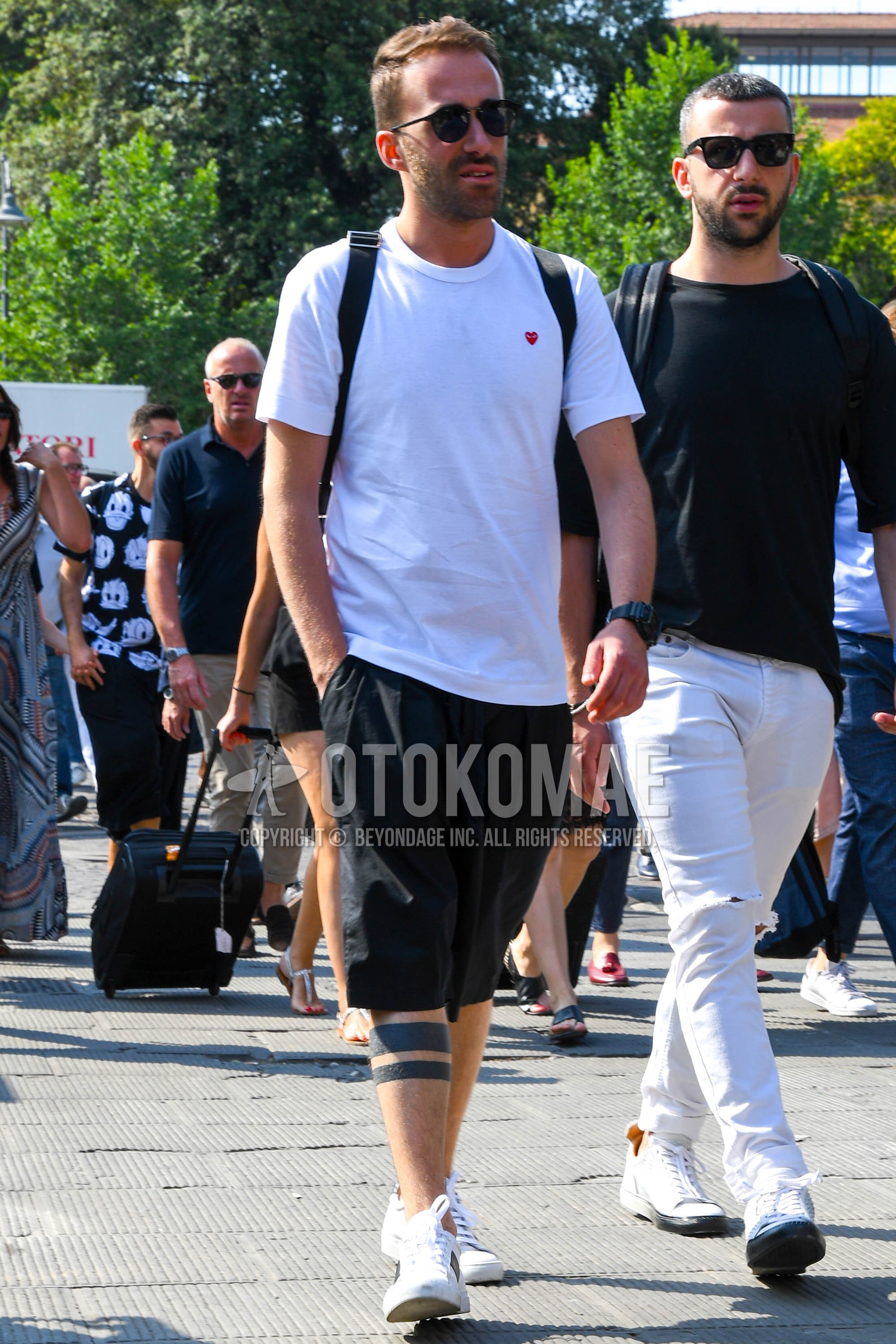 Men's summer outfit with plain sunglasses, white plain t-shirt, black plain short pants, white high-cut sneakers.