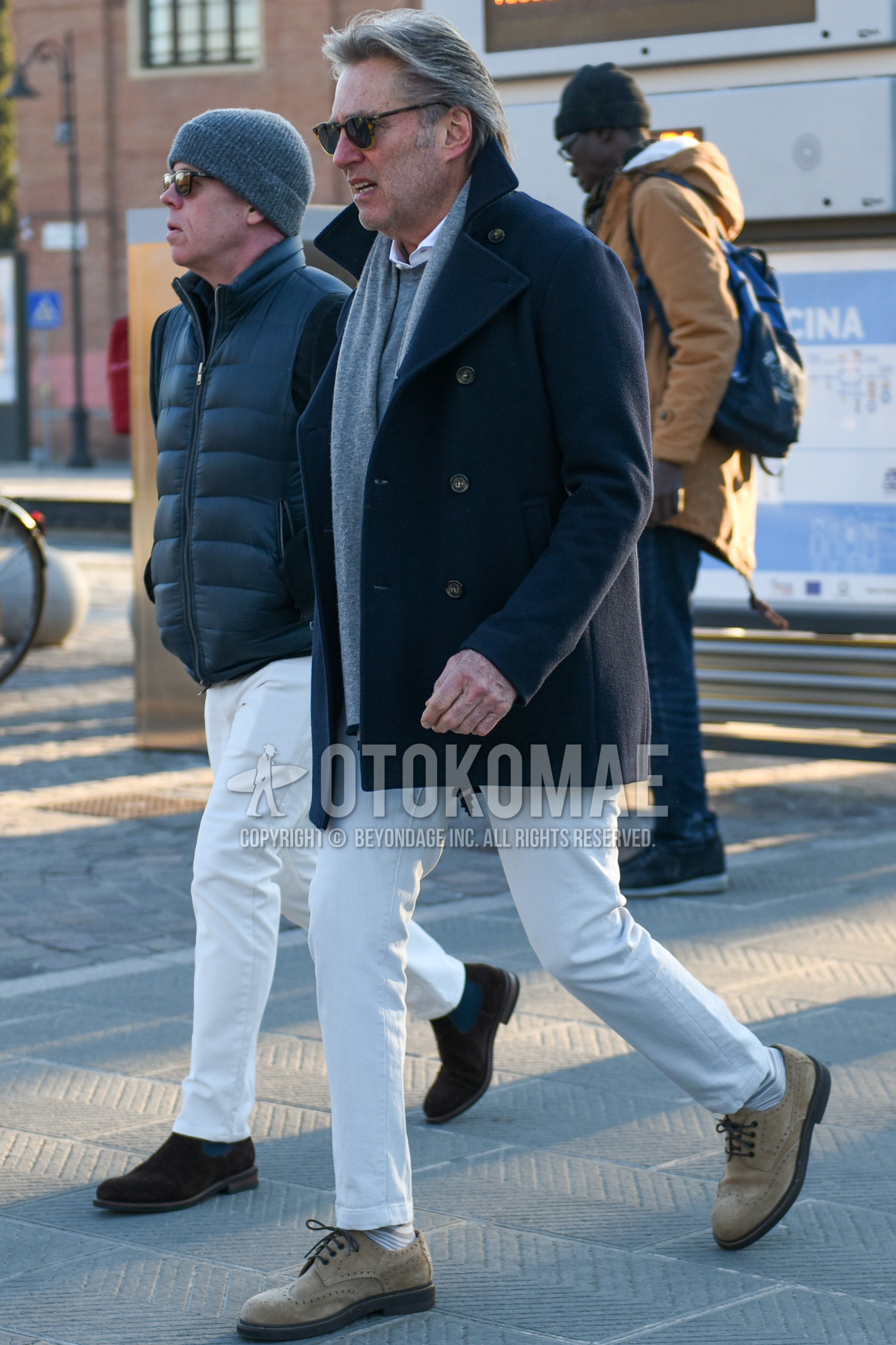 Men's autumn winter outfit with brown tortoiseshell sunglasses, gray plain scarf, navy plain p coat, gray plain sweater, white plain shirt, white plain cotton pants, white plain ankle pants, white horizontal stripes socks, beige wing-tip shoes leather shoes.