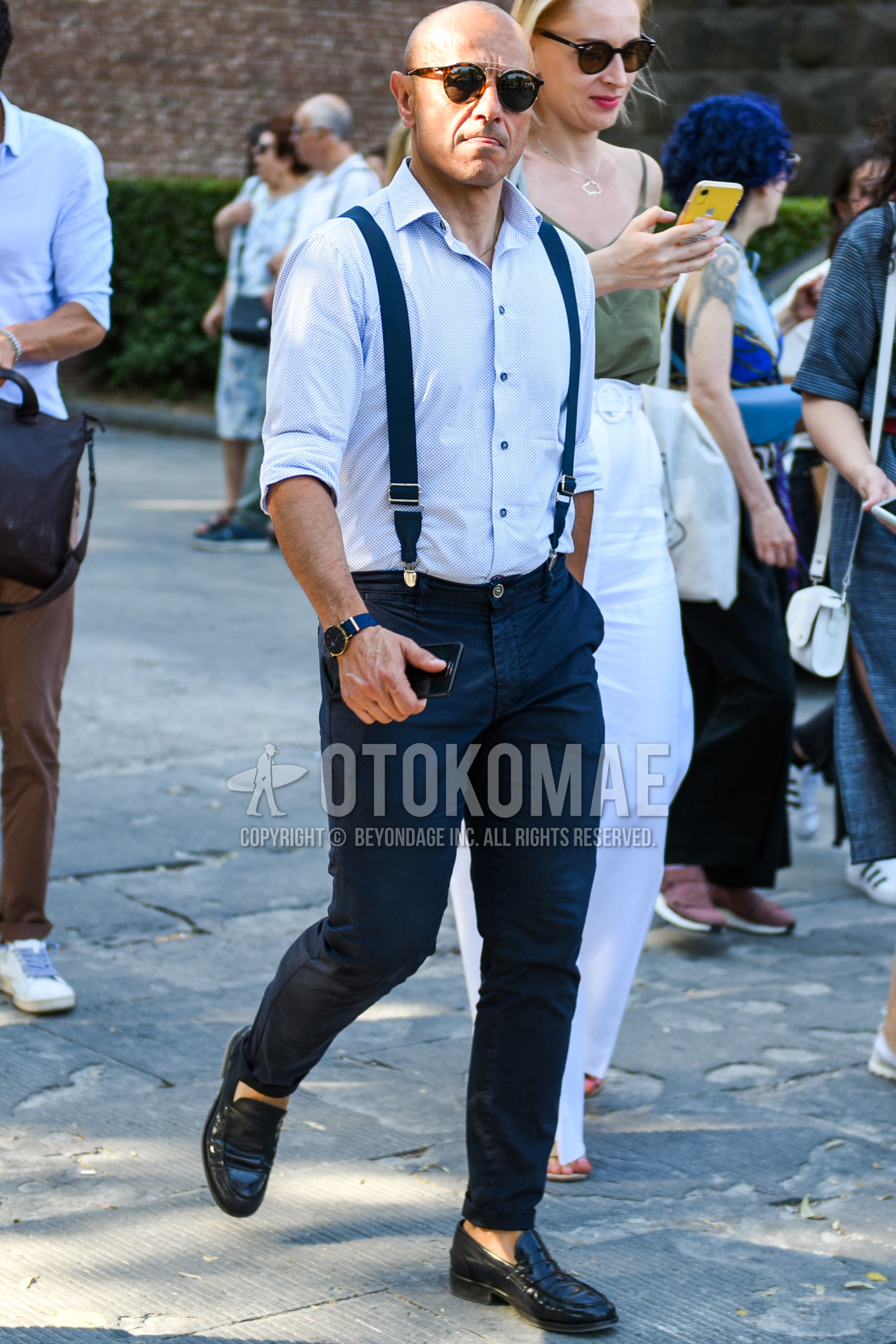 Men's spring summer autumn outfit with brown tortoiseshell sunglasses, white plain shirt, navy plain cotton pants, black coin loafers leather shoes.
