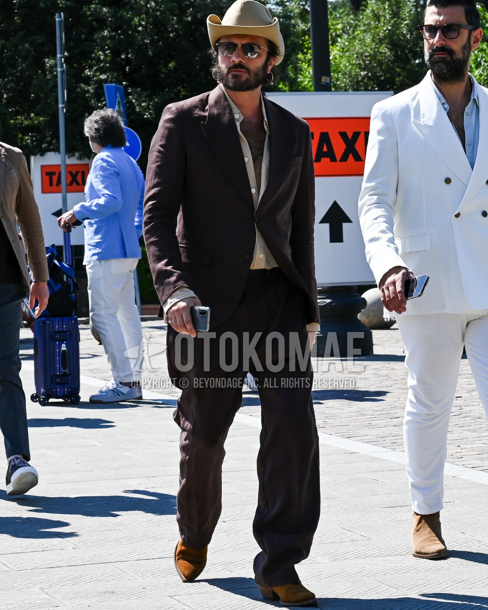 Men's spring summer autumn outfit with beige plain hat, black plain sunglasses, beige plain shirt, brown  boots, brown suede shoes leather shoes, brown plain suit.