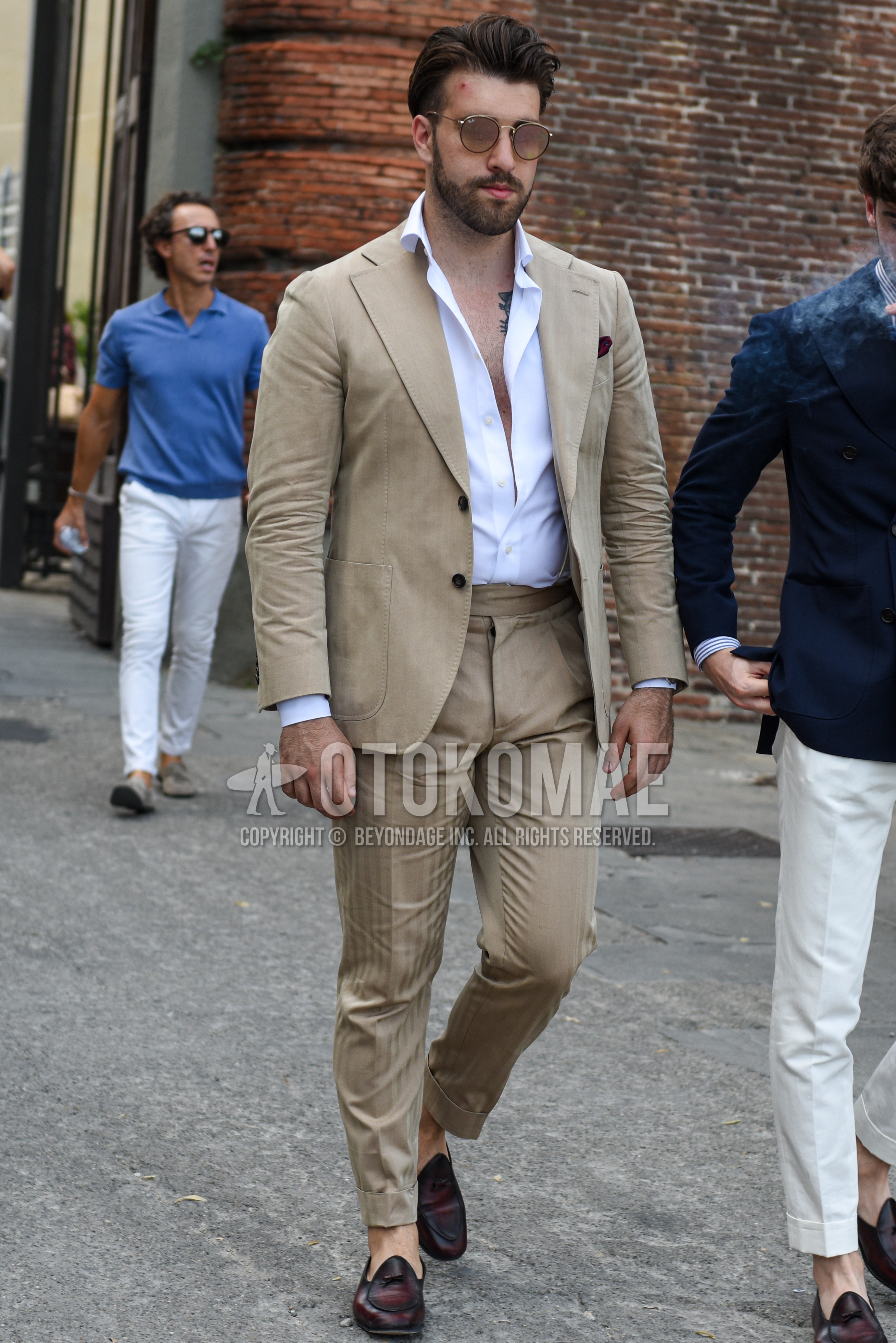 Men's spring summer autumn outfit with brown plain sunglasses, white plain shirt, brown  loafers leather shoes, beige plain suit.