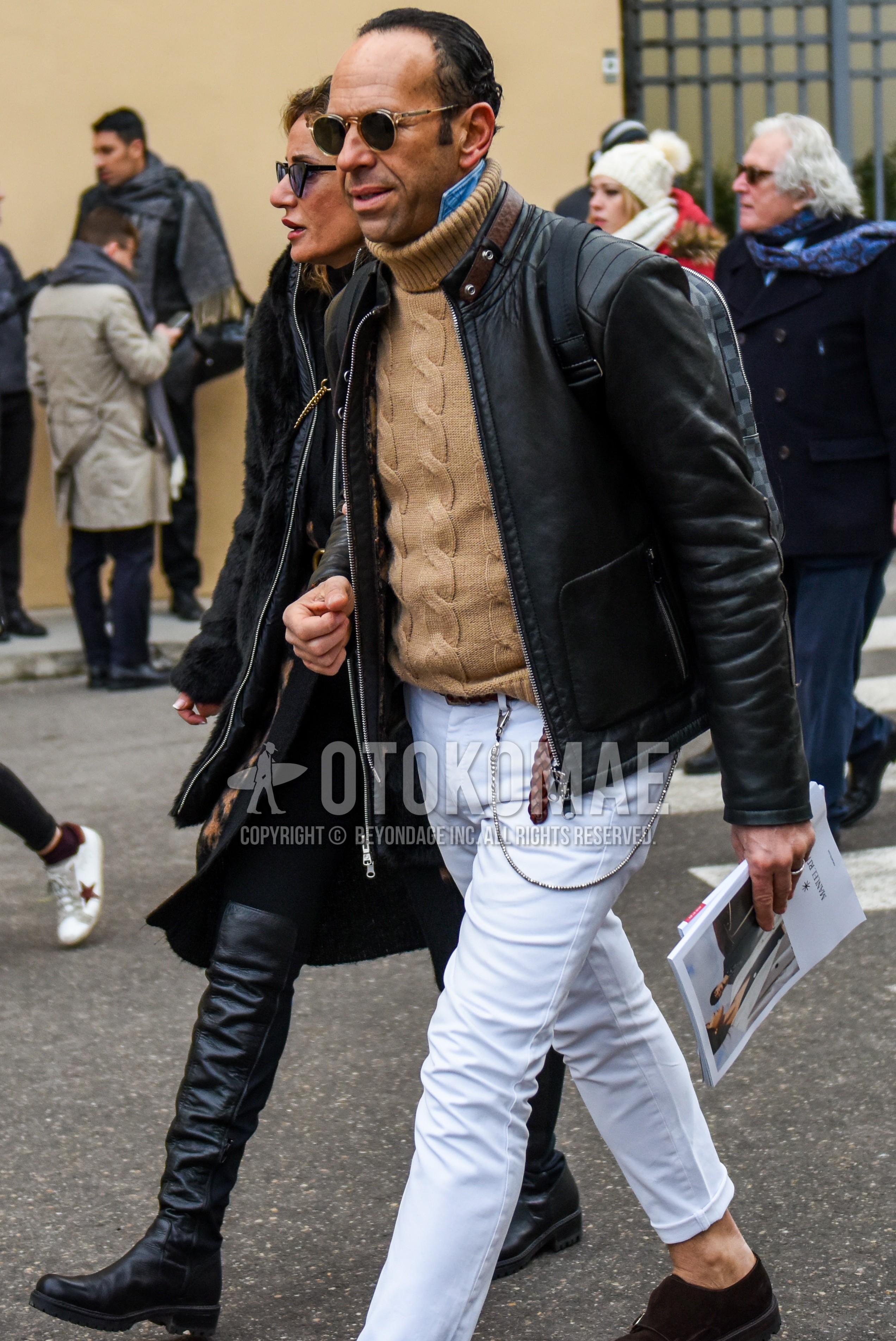 Men's winter outfit with plain sunglasses, black plain riders jacket, brown plain turtleneck knit, white plain denim/jeans.