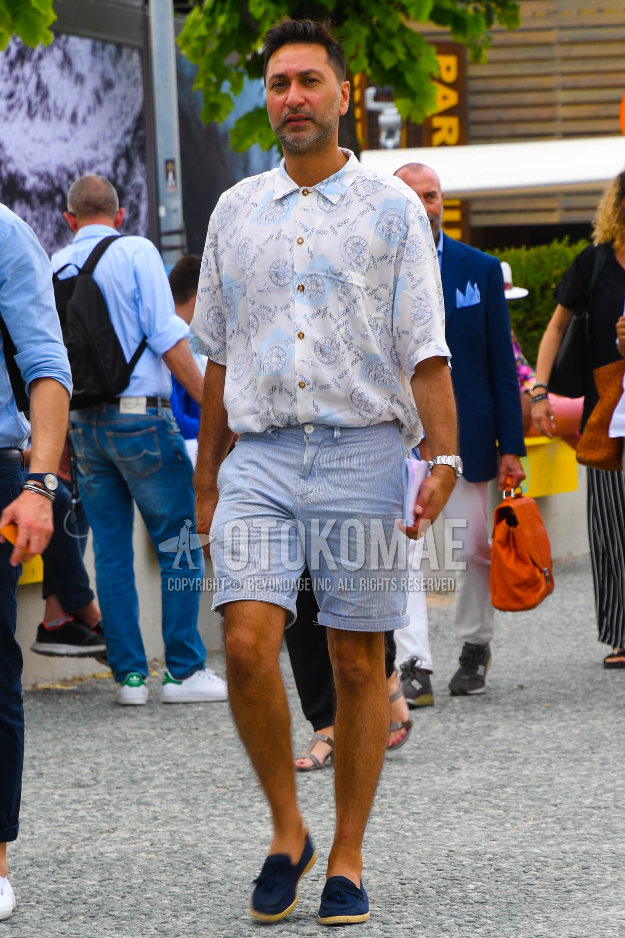 Men's summer outfit with white tops/innerwear shirt, light blue plain short pants, blue low-cut sneakers, blue tassel loafers leather shoes.