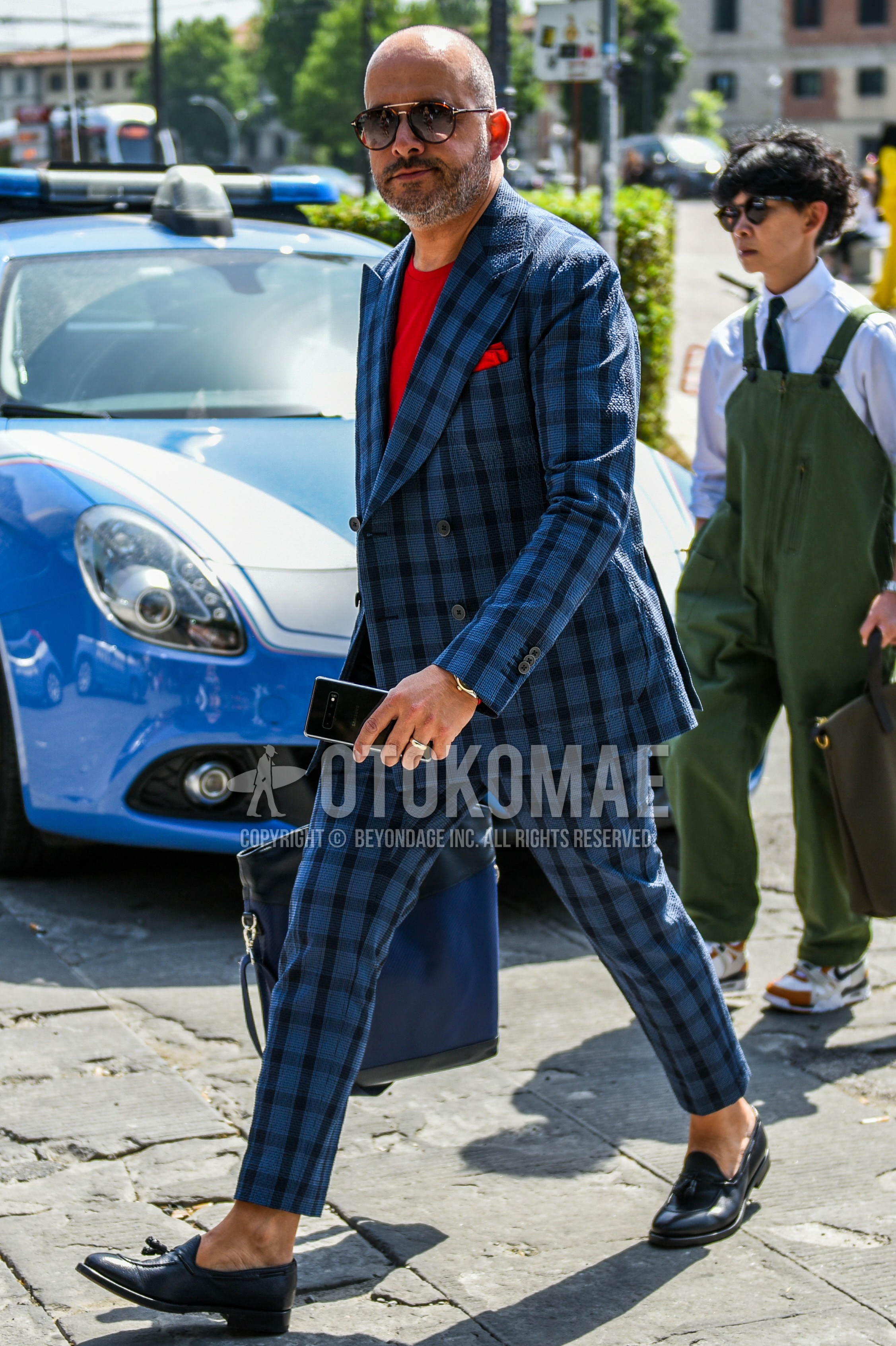 Men's spring autumn outfit with brown sunglasses, red plain t-shirt, navy tassel loafers leather shoes, blue check suit.