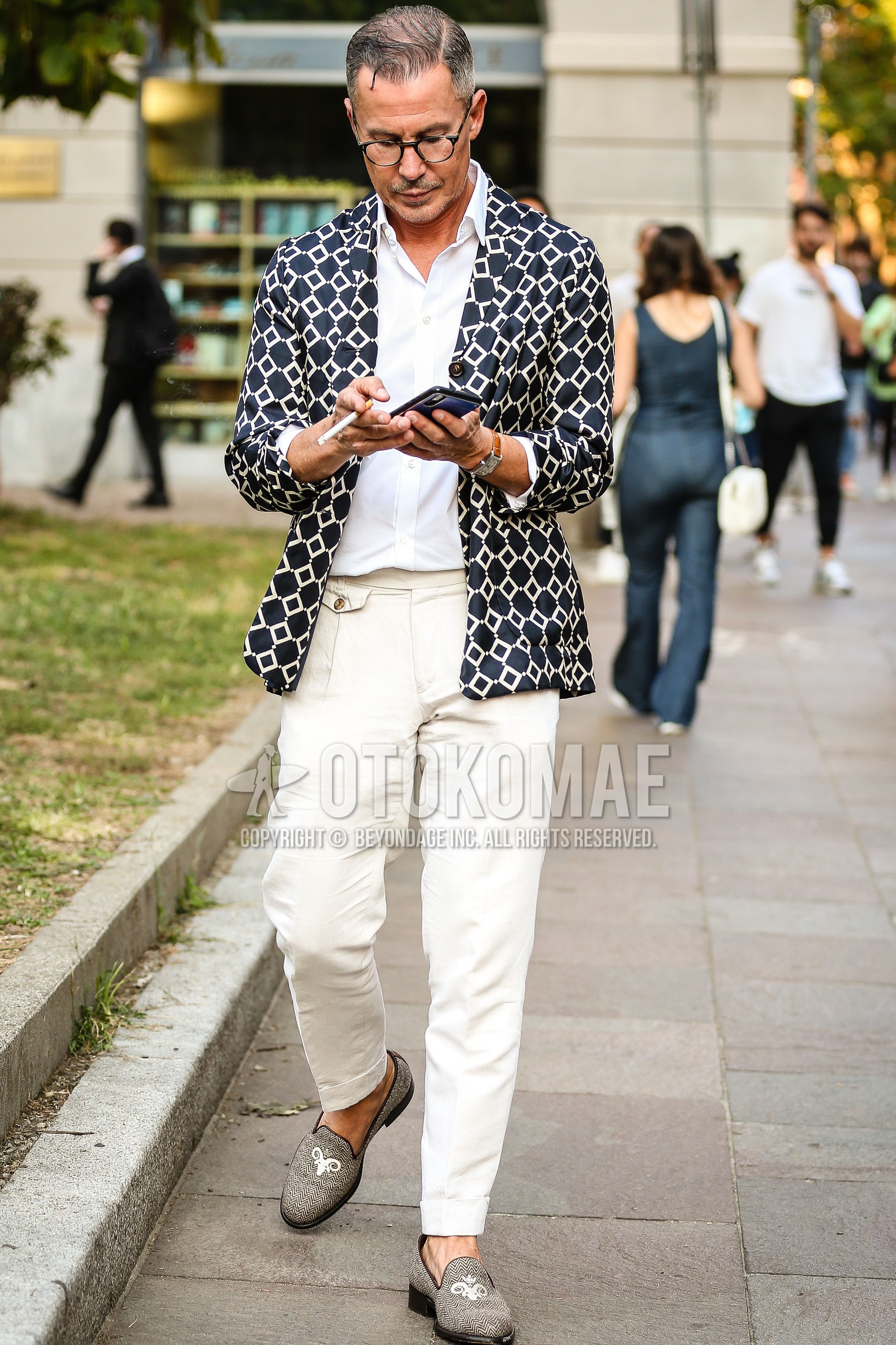 Men's spring summer outfit with black plain glasses, black navy outerwear tailored jacket, white plain shirt, white plain slacks, silver  loafers leather shoes.