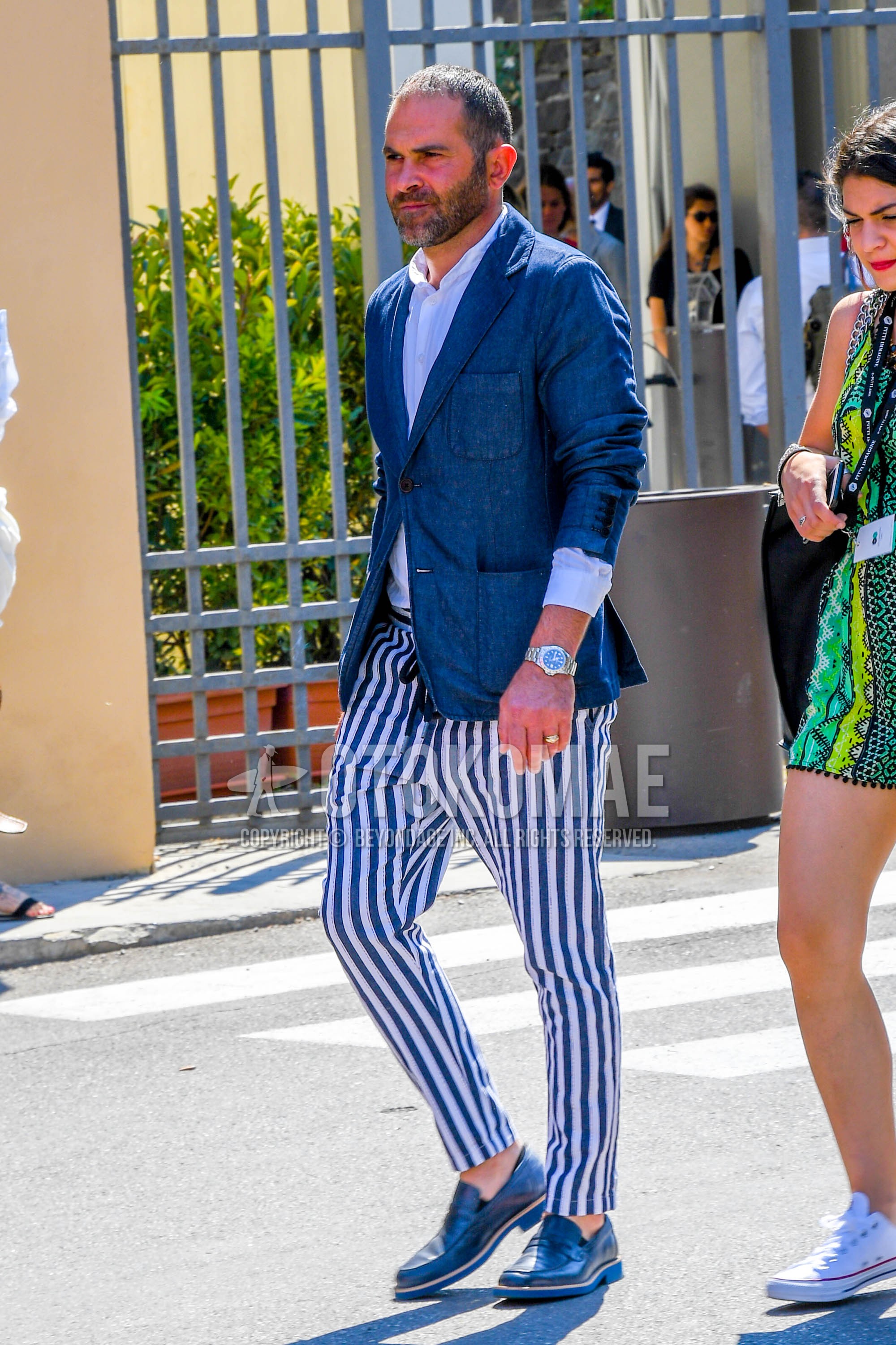 Men's spring summer autumn outfit with blue plain tailored jacket, white plain shirt, white blue stripes easy pants, white blue stripes ankle pants, blue coin loafers leather shoes.