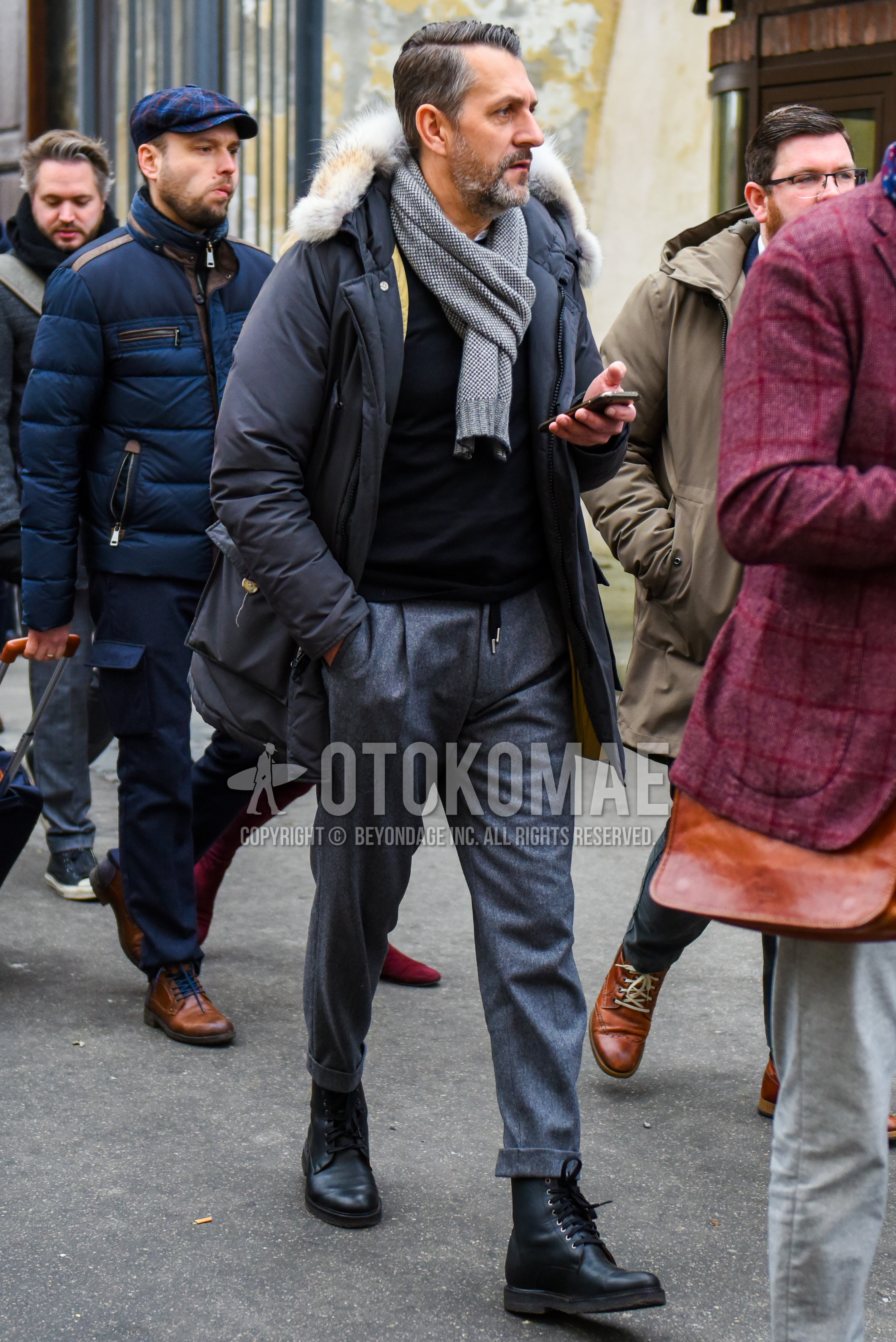 Men's winter outfit with gray plain scarf, gray plain down jacket, black plain sweater, gray plain easy pants, black  boots.