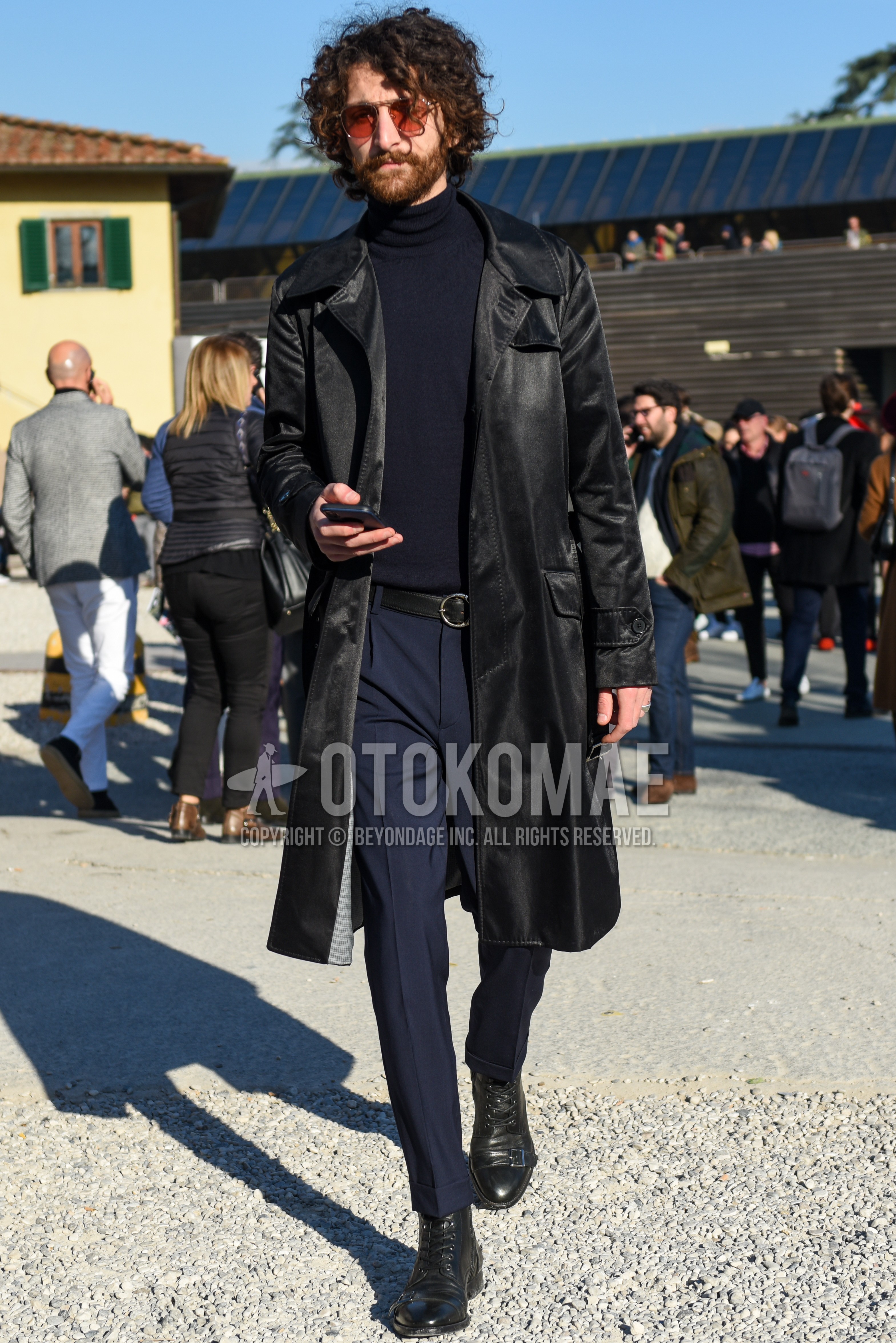 Men's autumn winter outfit with silver plain sunglasses, black plain stenkarrer coat, dark gray plain turtleneck knit, black plain leather belt, navy plain slacks, black  boots.