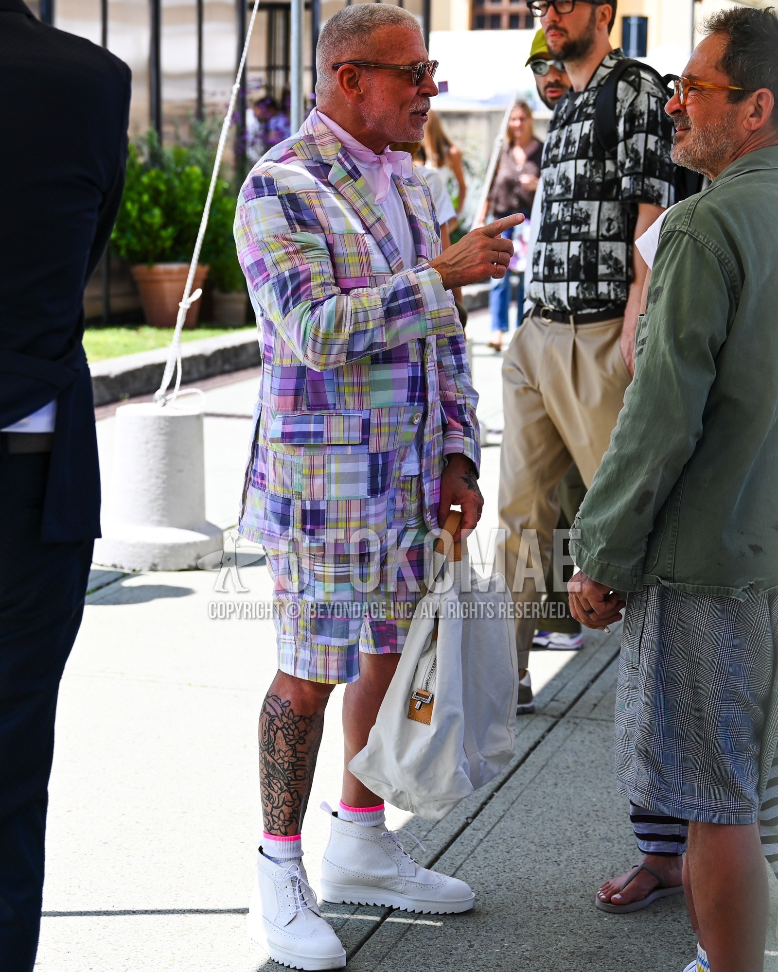 Men's spring summer outfit with brown plain sunglasses, purple plain bandana/neckerchief, purple stripes t-shirt, white plain socks, white high-cut sneakers, purple check casual setup.