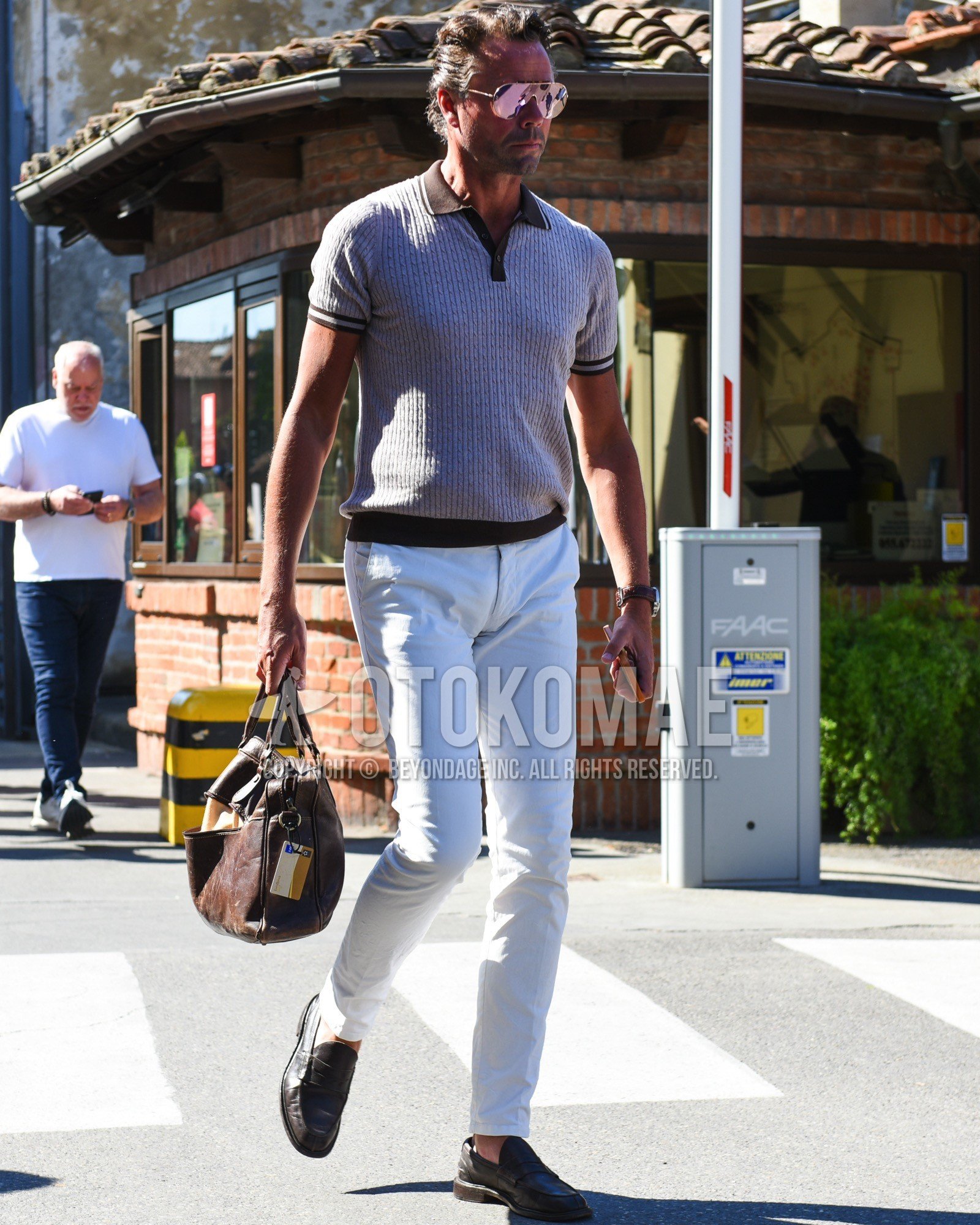 Men's spring summer outfit with gold plain sunglasses, gray brown plain polo shirt, white plain cotton pants, brown coin loafers leather shoes, brown plain briefcase/handbag.