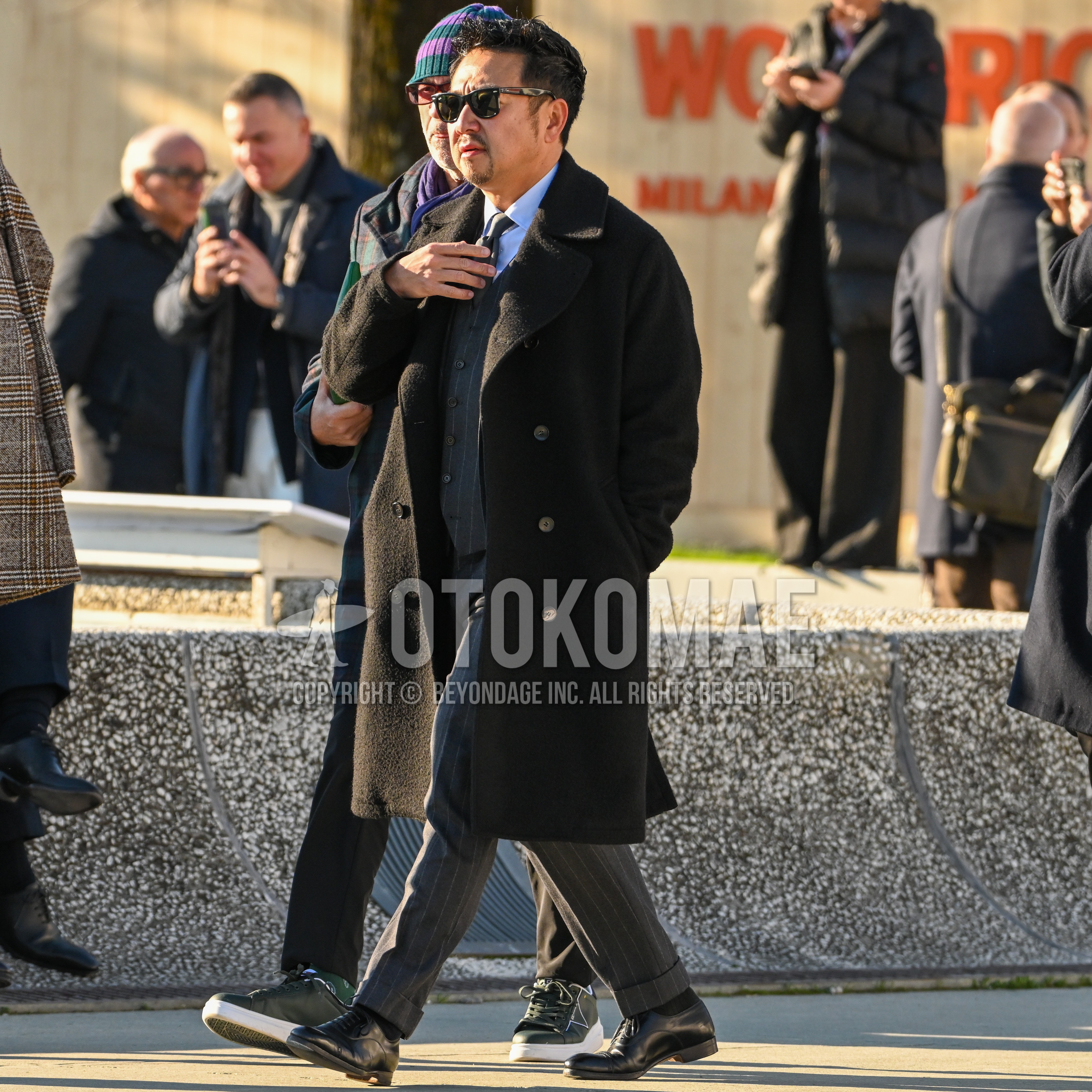 Men's autumn winter outfit with black plain sunglasses, black plain chester coat, light blue plain shirt, black plain socks, black straight-tip shoes leather shoes, dark gray stripes three-piece suit.