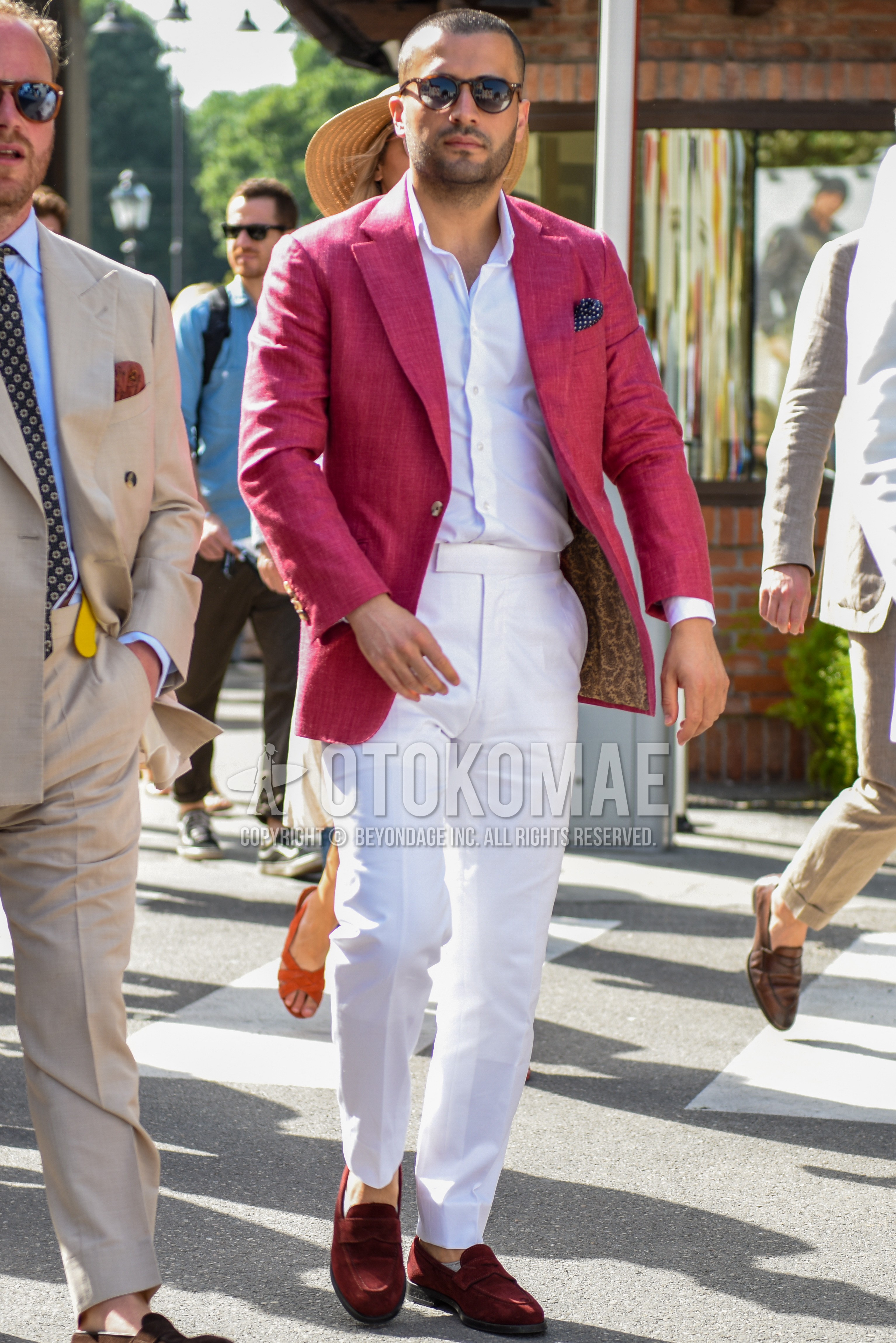 Men's spring summer outfit with brown tortoiseshell sunglasses, red plain tailored jacket, white plain shirt, white plain beltless pants, red coin loafers leather shoes.