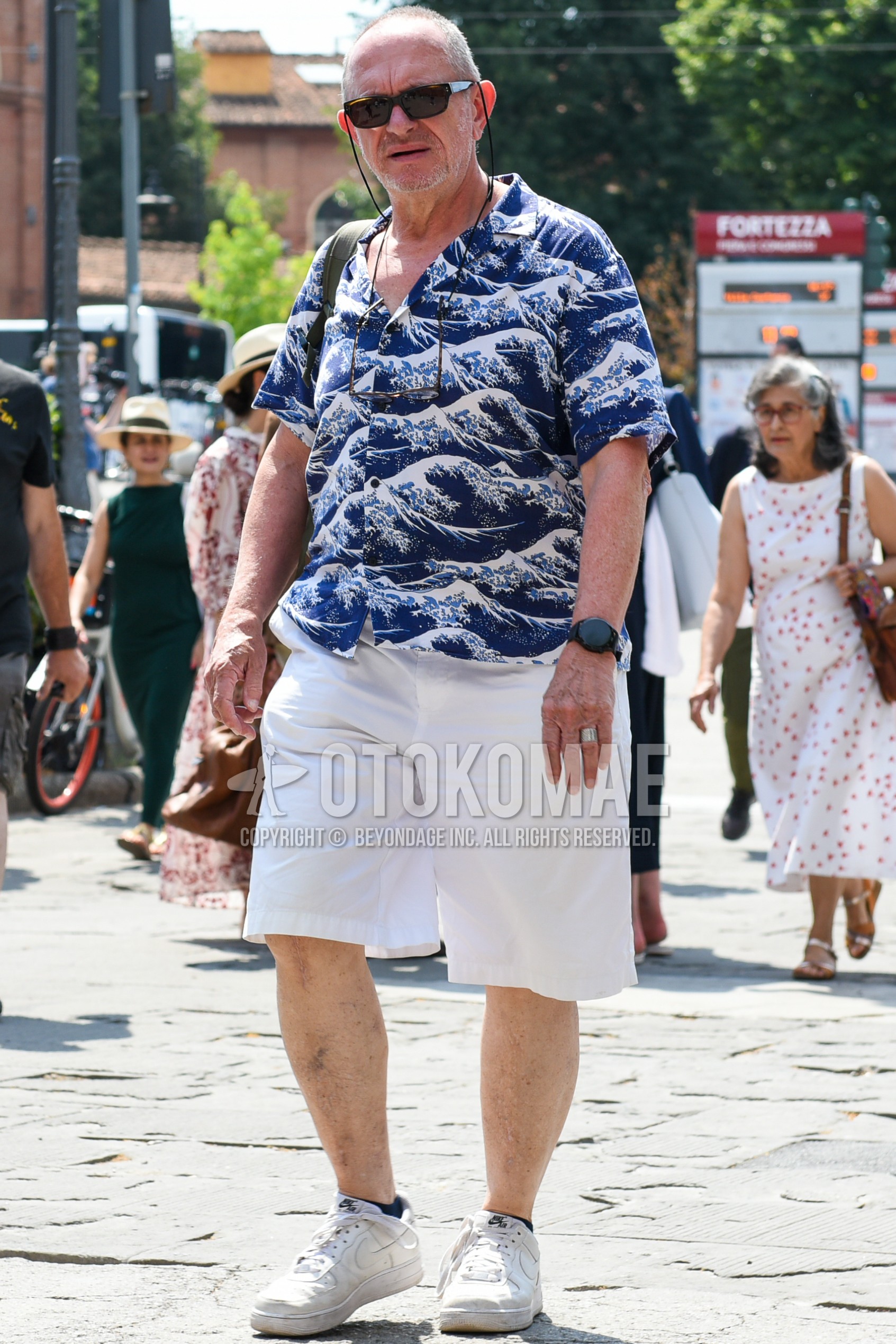 Men's summer outfit with black plain sunglasses, blue tops/innerwear shirt, white plain short pants, black plain socks, white low-cut sneakers.