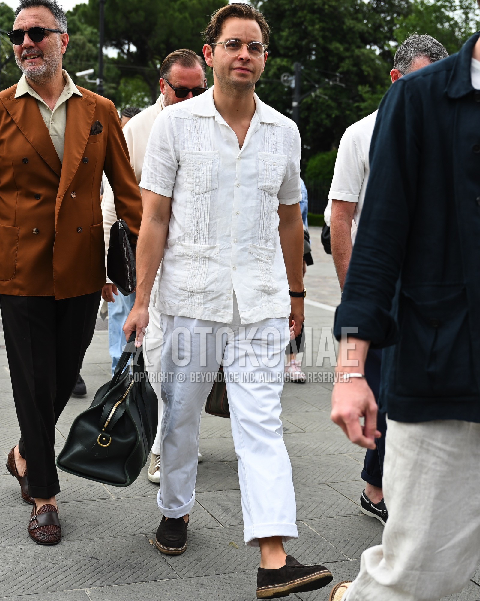 Men's spring summer outfit with clear plain sunglasses, white plain shirt, white plain denim/jeans, navy  loafers leather shoes, black plain boston bag.