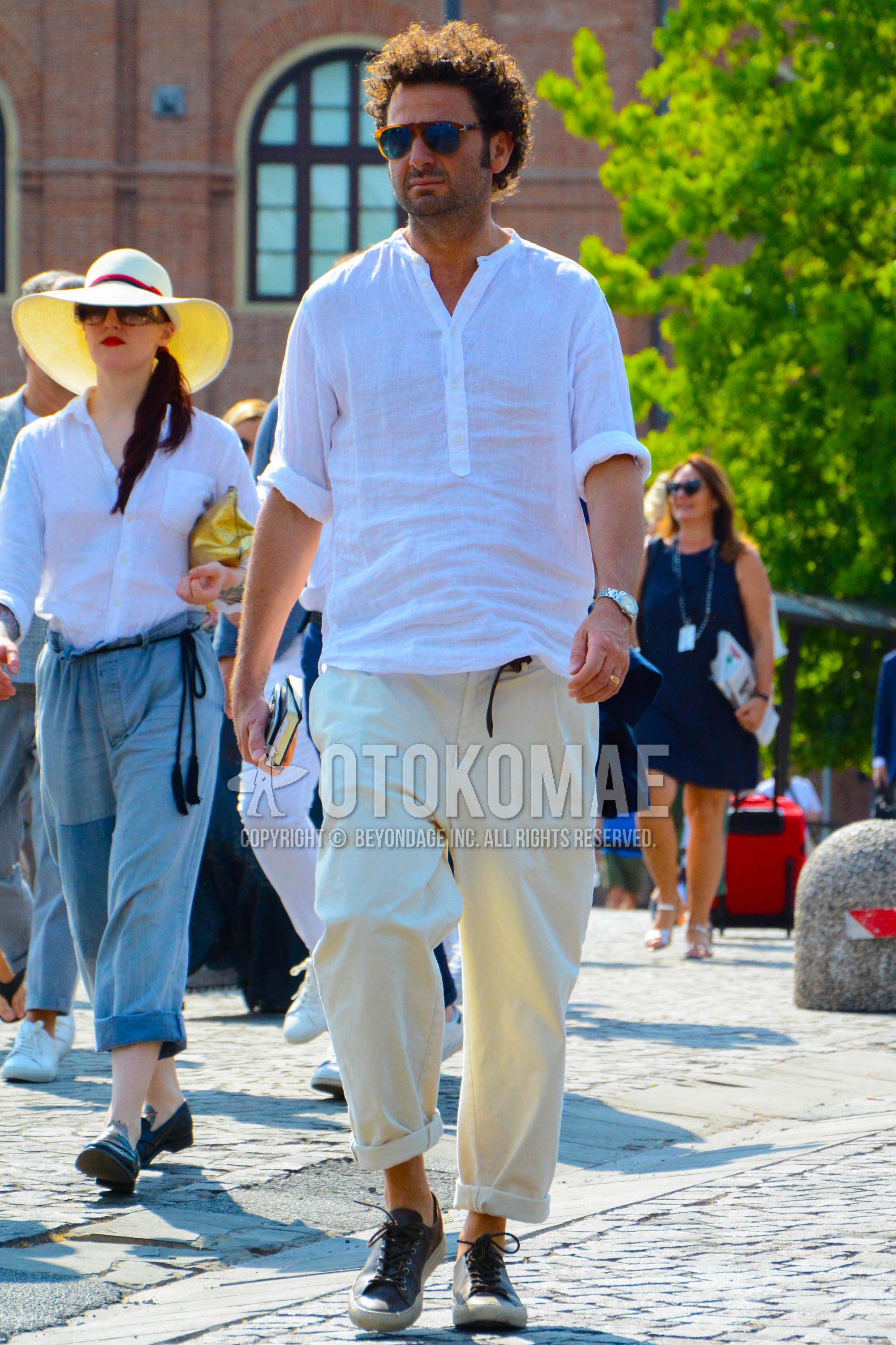 Men's spring summer autumn outfit with plain sunglasses, white plain shirt, white plain wide pants, black low-cut sneakers.