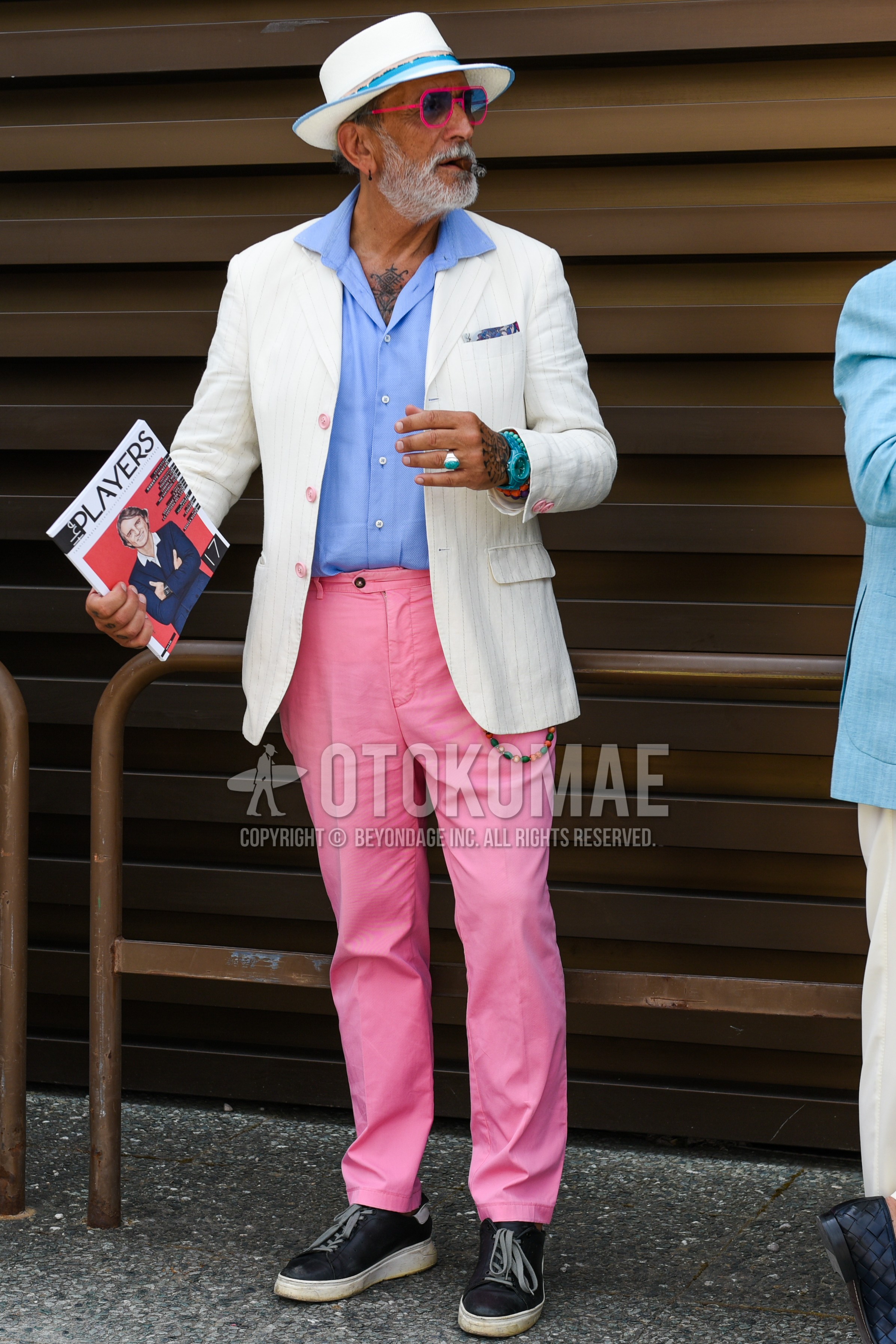Men's spring summer outfit with white plain hat, pink plain sunglasses, white plain tailored jacket, light blue plain shirt, pink plain cotton pants, black low-cut sneakers.