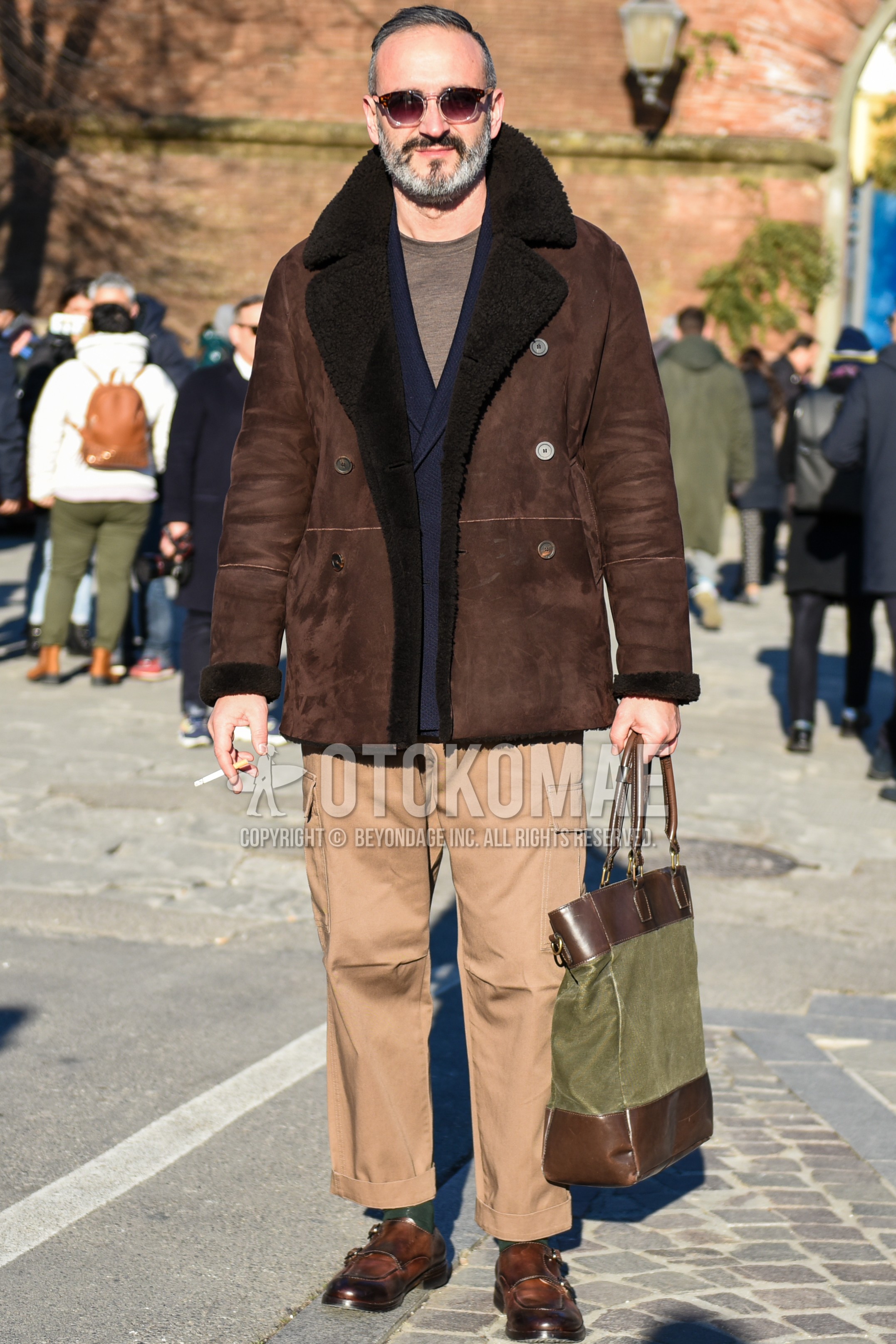 Men's autumn winter outfit with brown tortoiseshell sunglasses, brown plain p coat, brown plain leather jacket, navy plain tailored jacket, gray plain t-shirt, beige plain cargo pants, beige plain chinos, olive green plain socks, brown monk shoes leather shoes.
