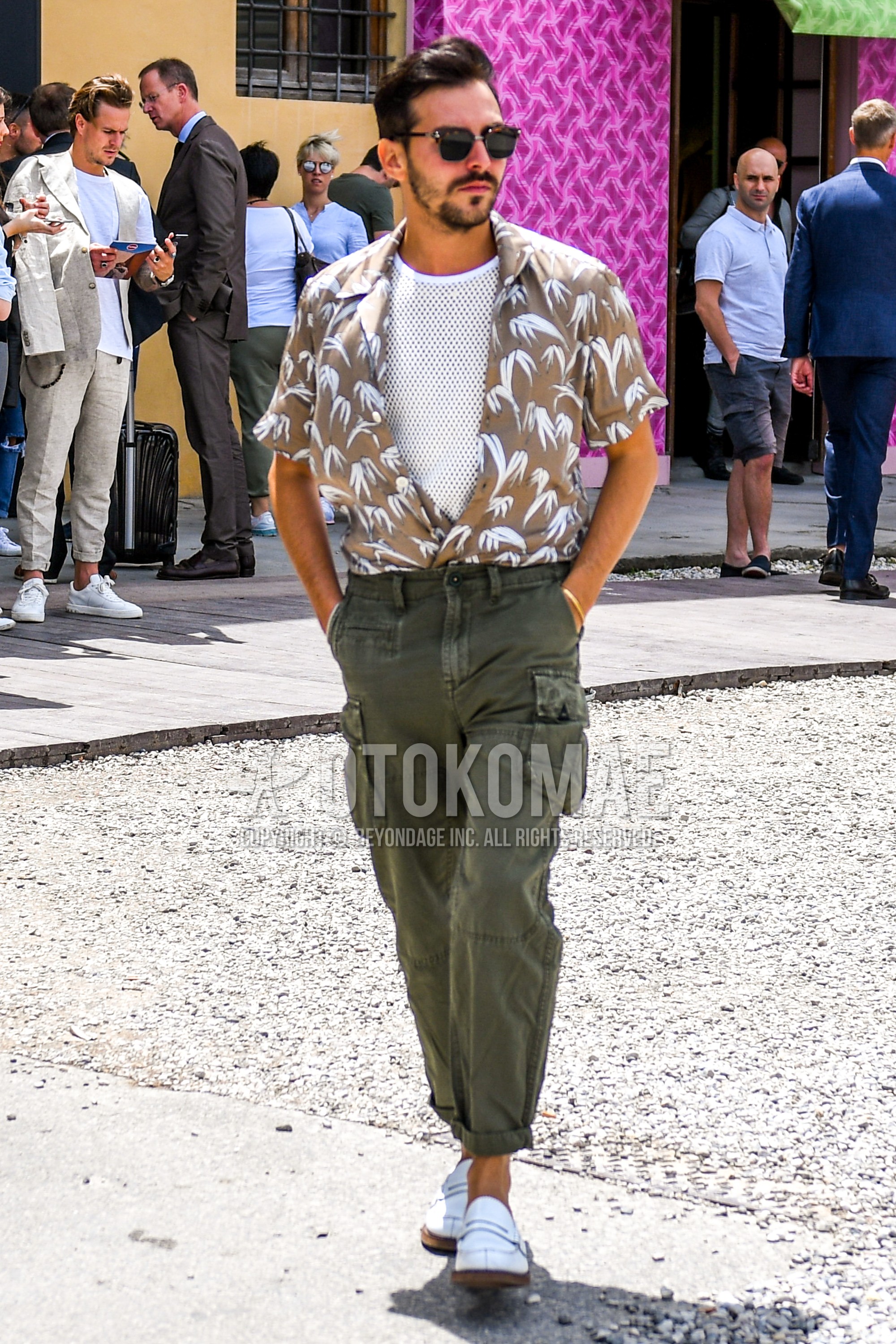Men's summer outfit with plain sunglasses, beige tops/innerwear shirt, white plain t-shirt, green plain cargo pants, white coin loafers leather shoes.