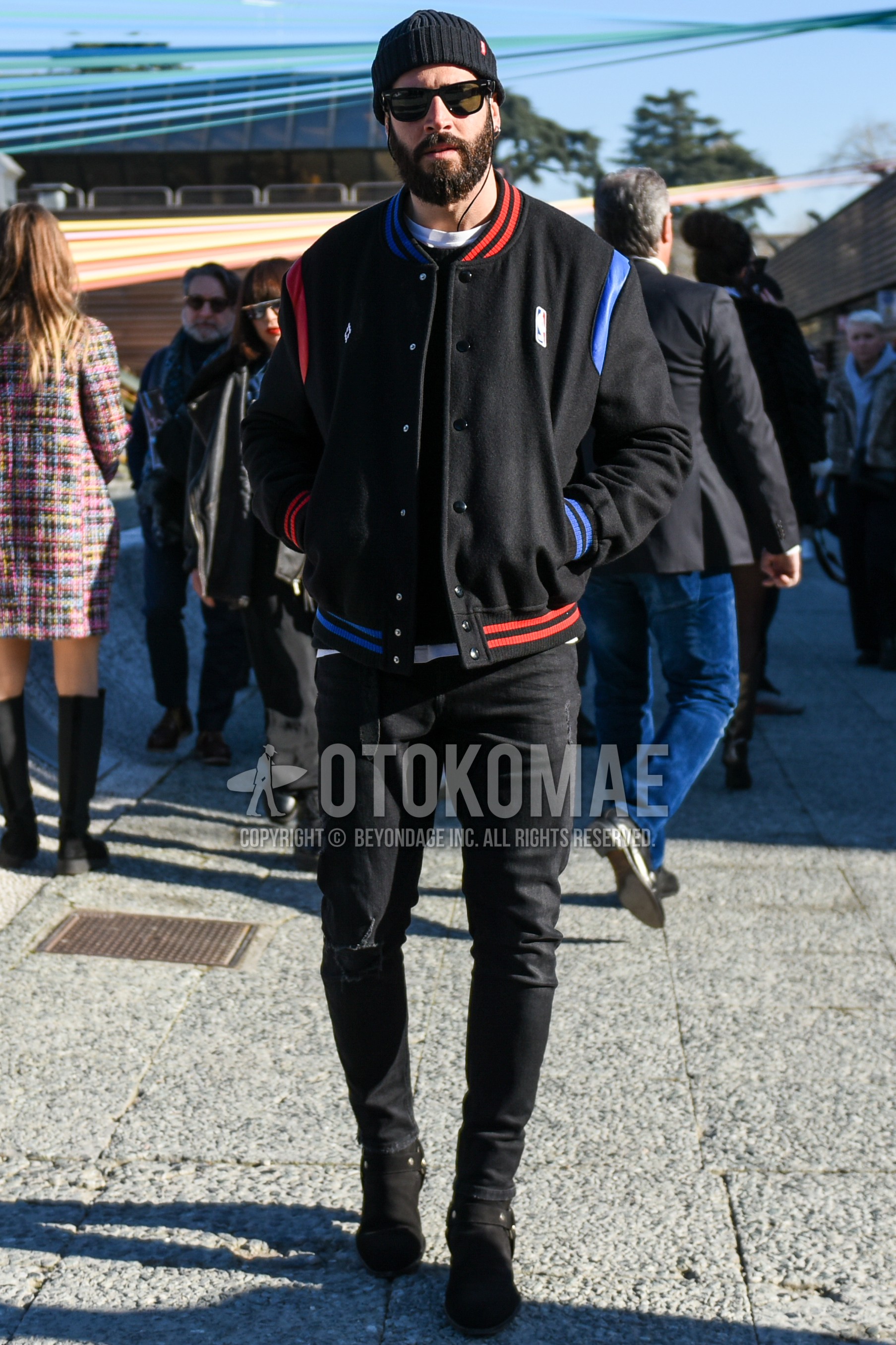 Men's autumn winter outfit with black plain knit cap, black plain sunglasses, black one point stadium jacket, black plain sweater, white plain t-shirt, black plain damaged jeans, black  boots.
