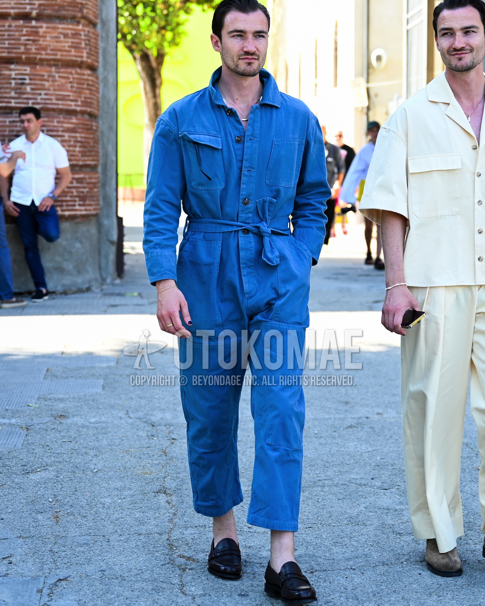 Men's spring summer autumn outfit with blue plain jumpsuit, black coin loafers leather shoes.