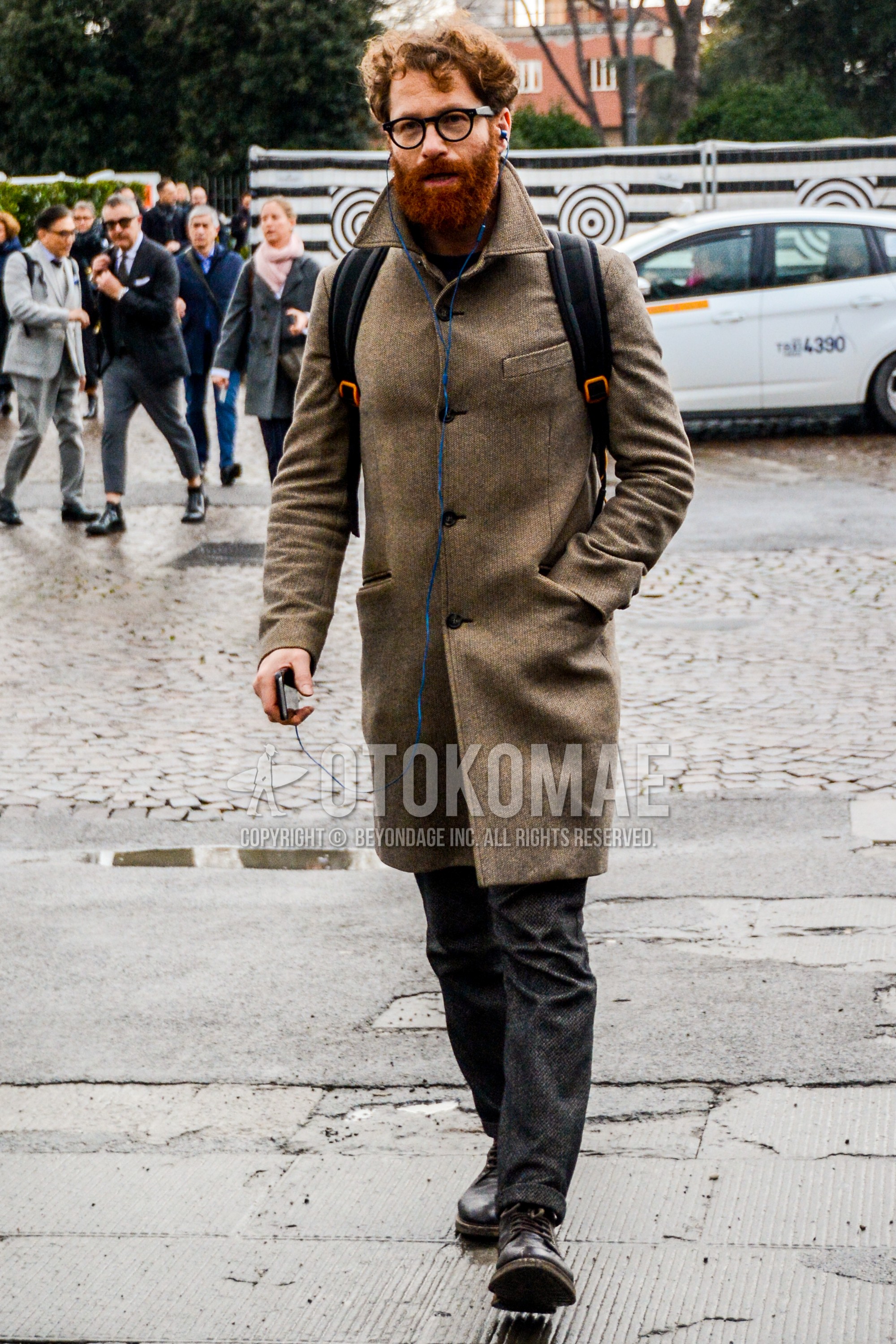 Men's autumn winter outfit with black plain glasses, brown plain stenkarrer coat, dark gray plain slacks, brown work boots.
