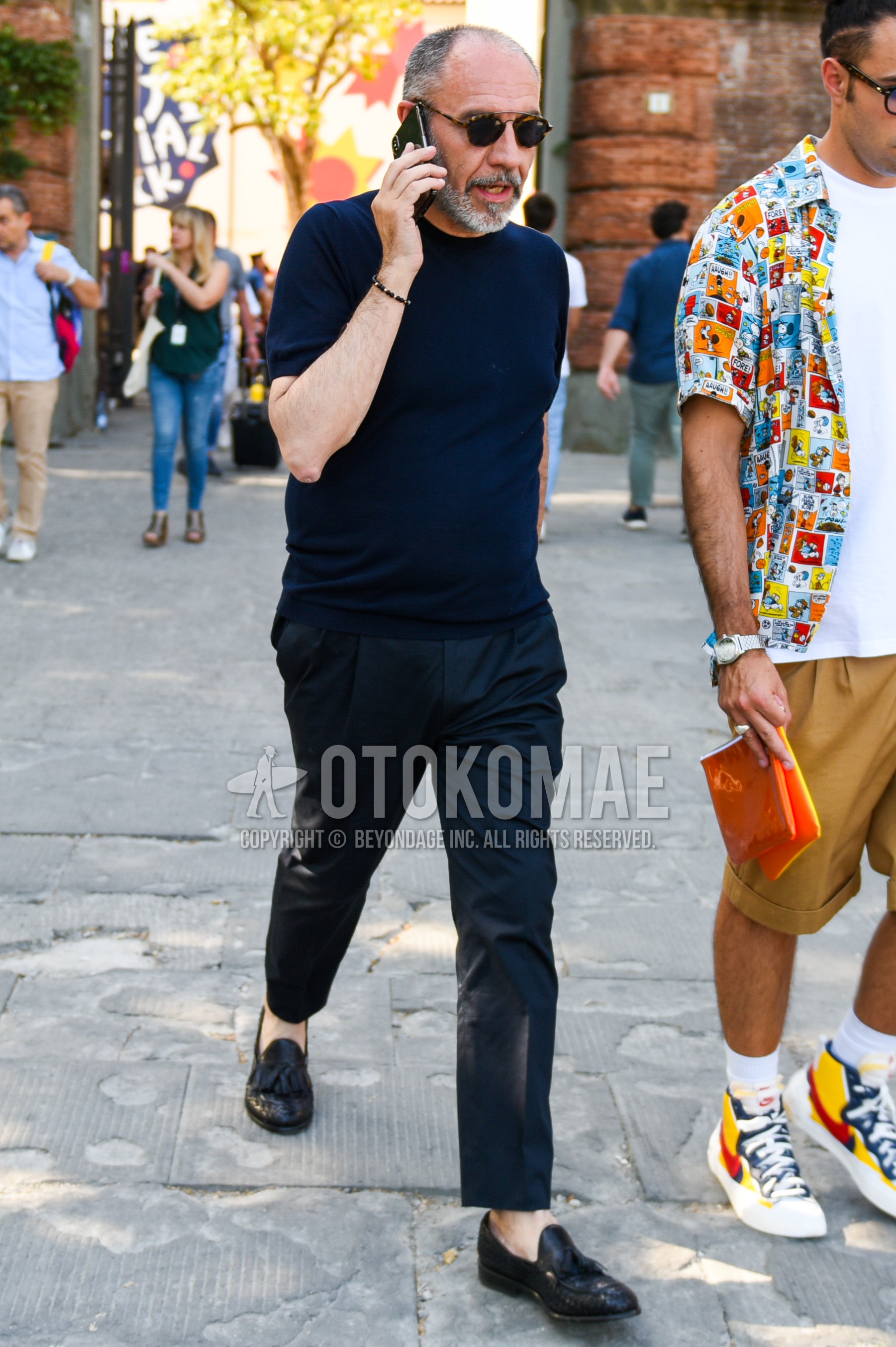 Men's summer outfit with black tortoiseshell sunglasses, navy plain t-shirt, black plain ankle pants, black tassel loafers leather shoes.