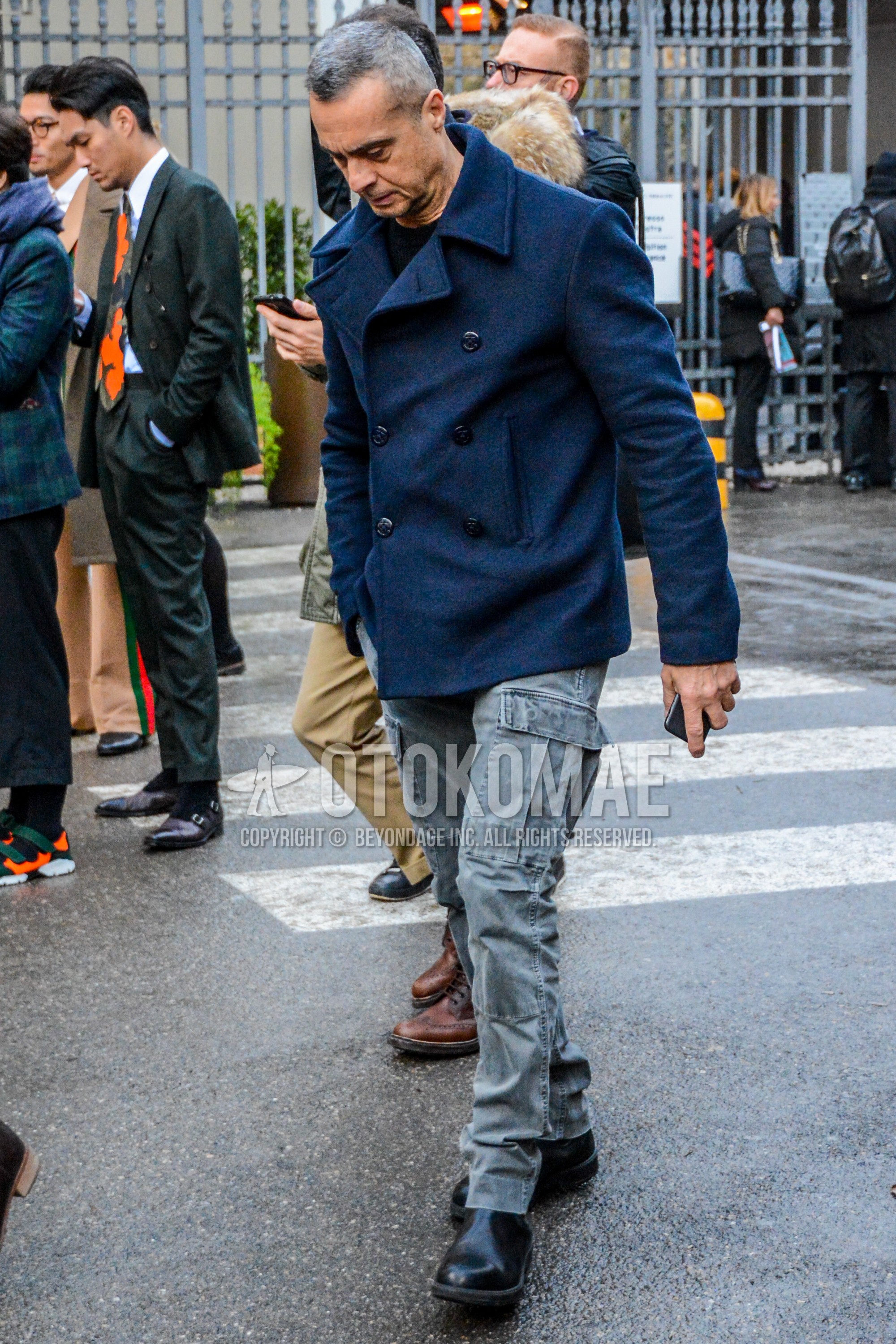 Men's winter outfit with navy plain p coat, navy plain sweater, gray plain cargo pants, black side-gore boots.