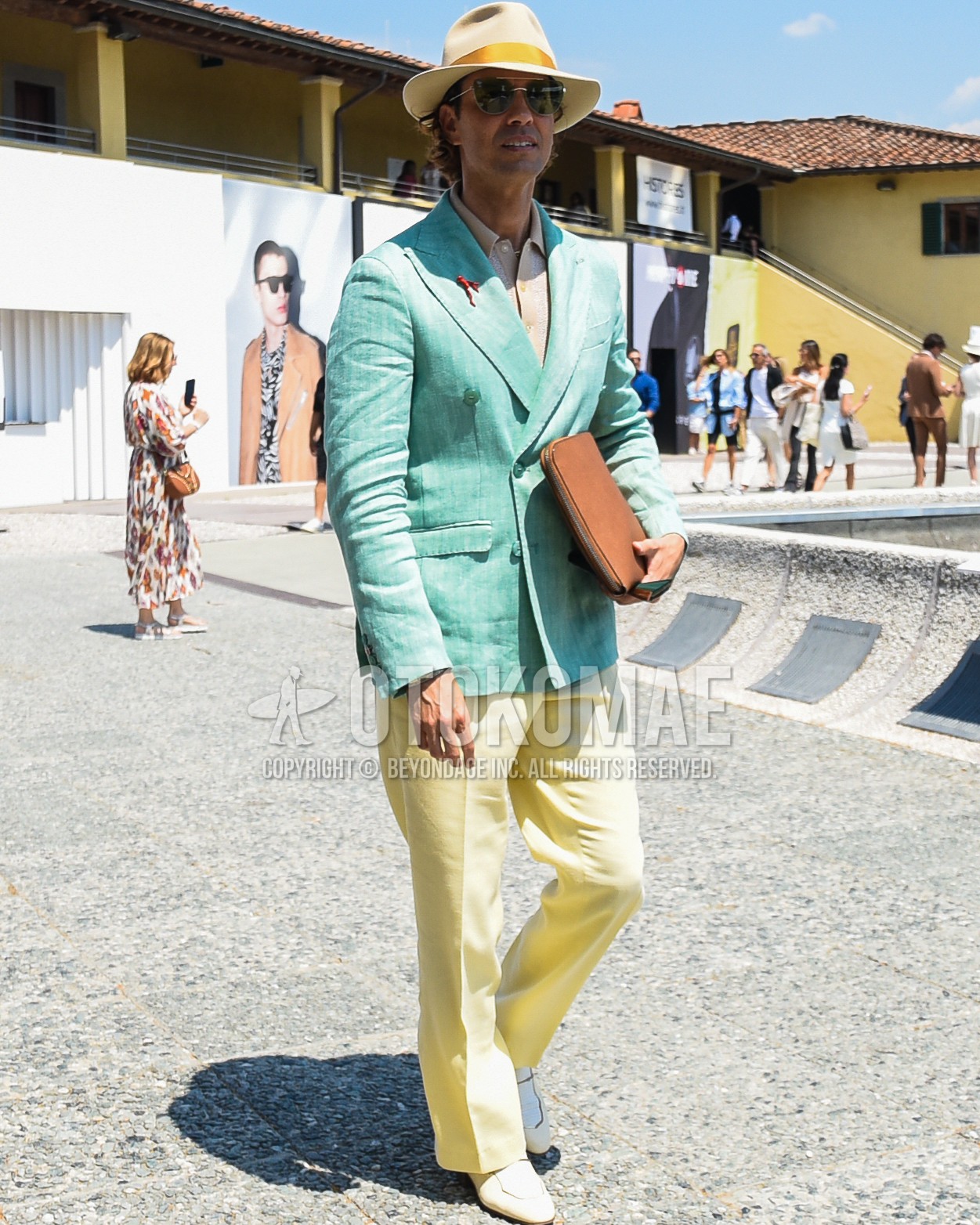 Men's spring summer autumn outfit with beige plain hat, gold plain sunglasses, green stripes tailored jacket, beige tops/innerwear polo shirt, yellow plain slacks, white  loafers leather shoes, brown plain clutch bag/second bag/drawstring bag.