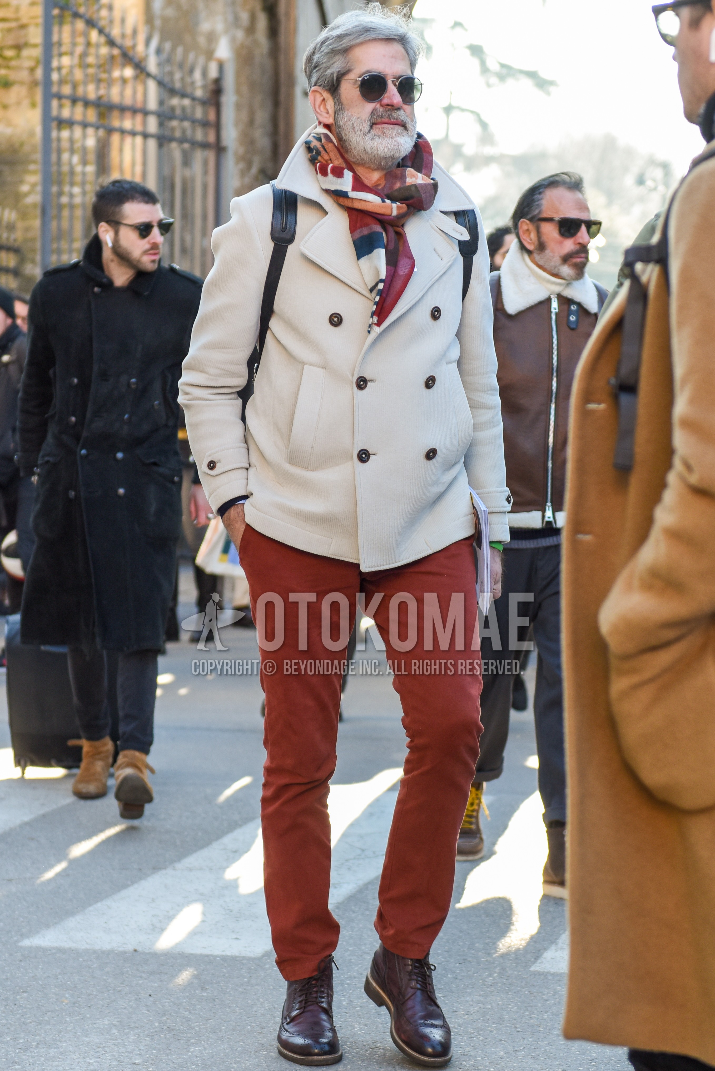 Men's winter outfit with silver plain sunglasses, multi-color scarf scarf, white plain p coat, brown plain chinos, brown  boots.