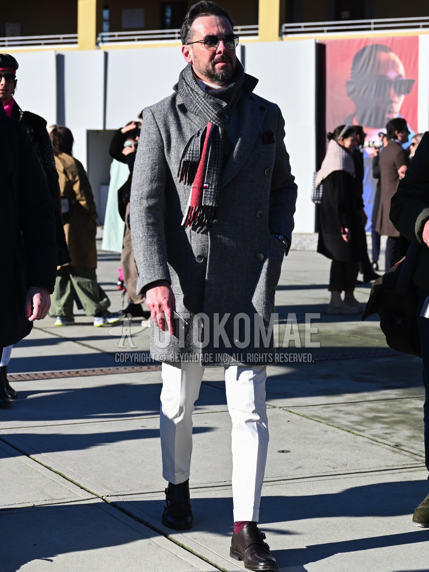 Men's autumn winter outfit with black plain sunglasses, gray check scarf, gray plain chester coat, white plain cotton pants, red plain socks, brown monk shoes leather shoes.