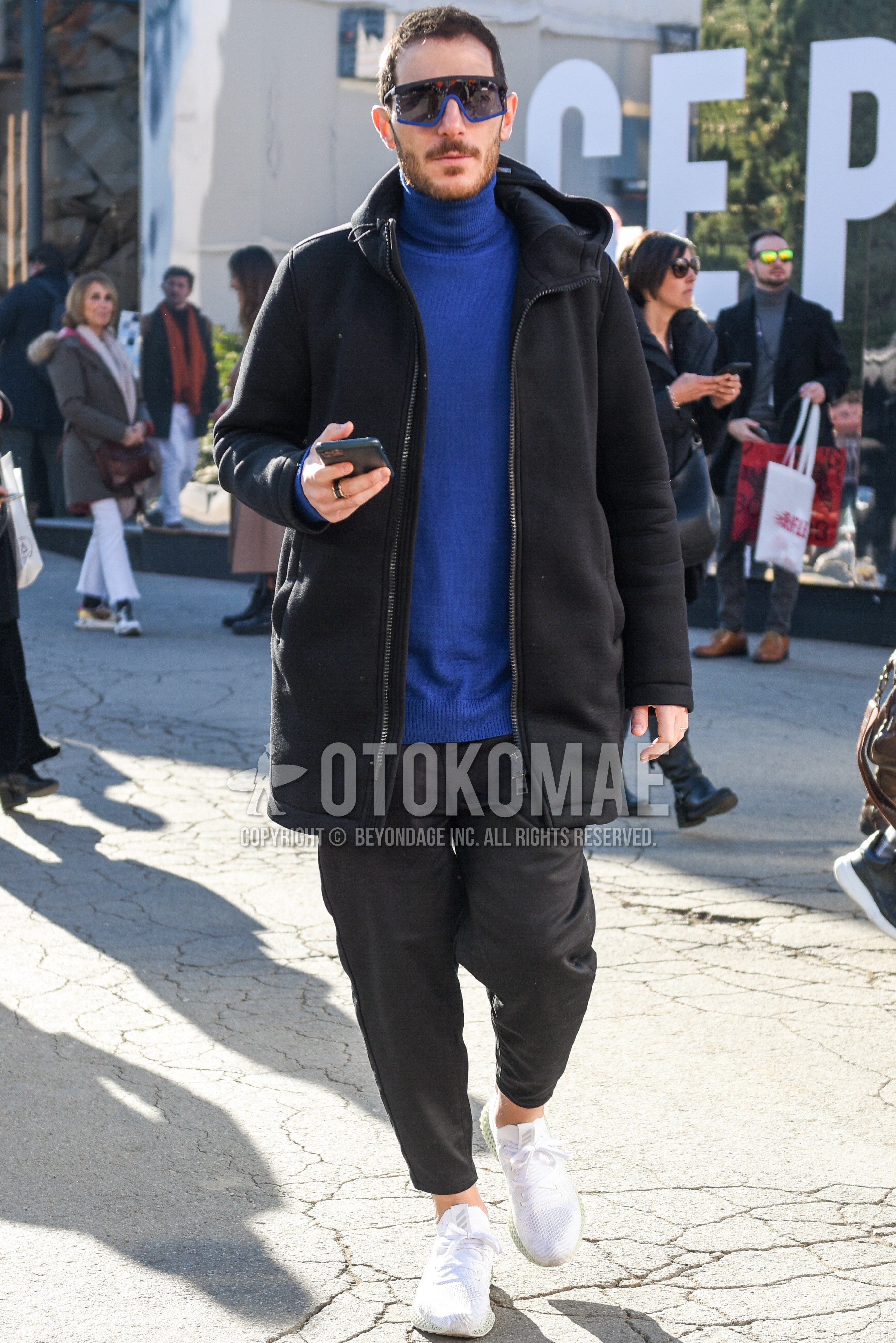Men's autumn winter outfit with black blue plain sunglasses, black plain hooded coat, gray plain turtleneck knit, gray plain ankle pants, white low-cut sneakers.