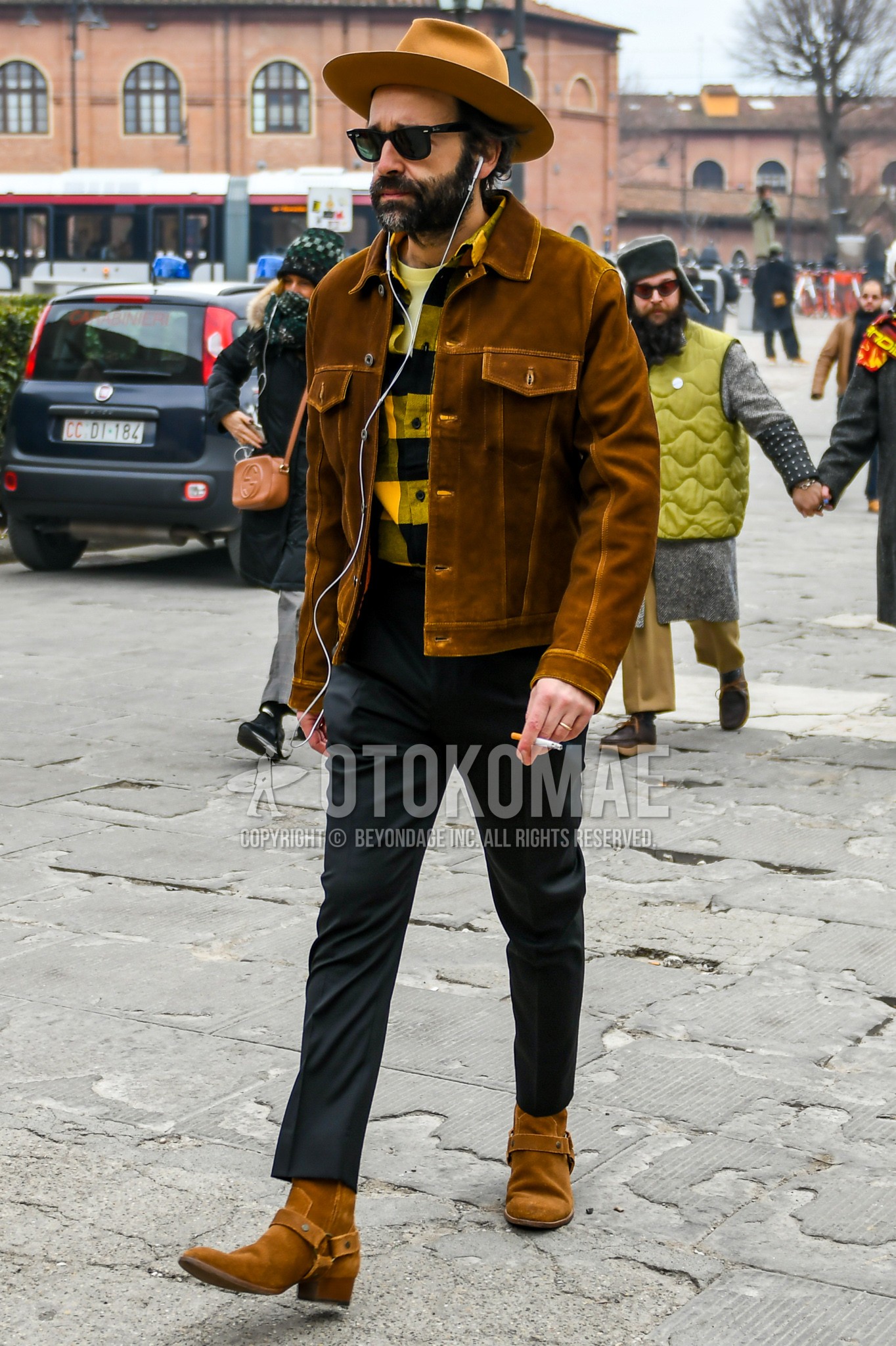 Men's winter outfit with brown plain hat, brown plain leather jacket, yellow check shirt, dark gray plain slacks, brown  boots.
