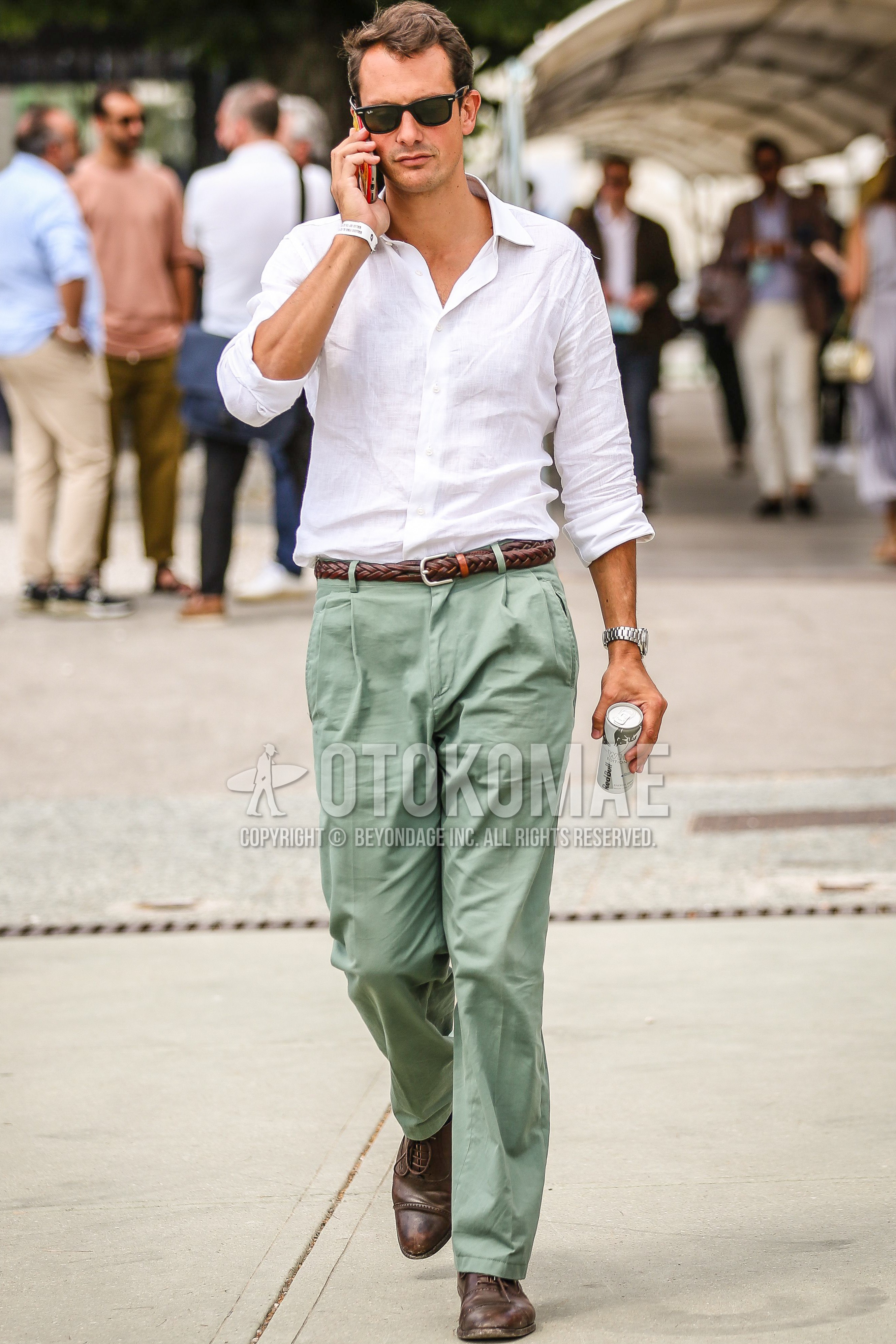 Men's spring summer outfit with black plain sunglasses, white plain shirt, brown plain braided belt, olive green plain cargo pants, brown straight-tip shoes leather shoes.