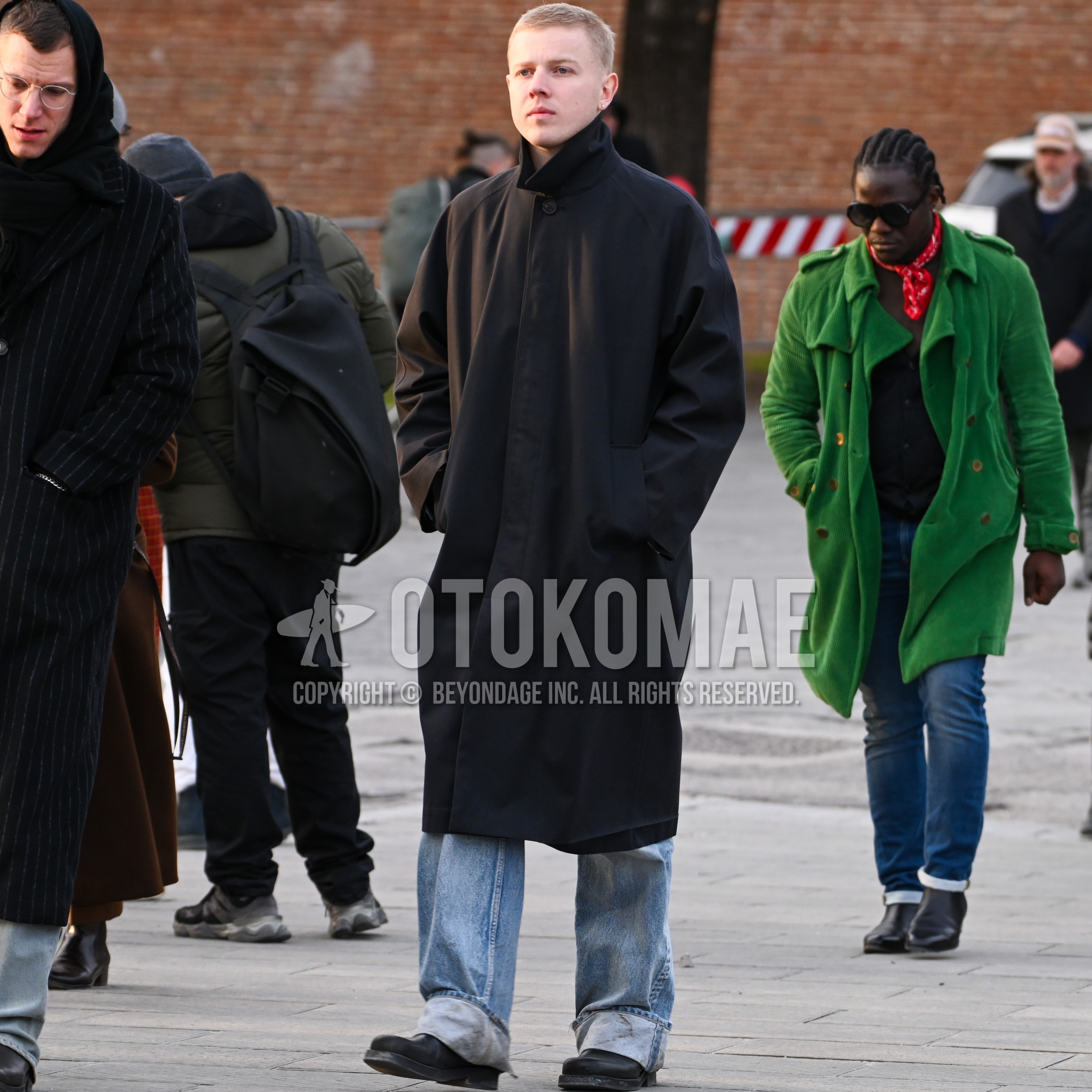 Men's autumn winter outfit with black plain stenkarrer coat, light blue plain denim/jeans, black  boots.