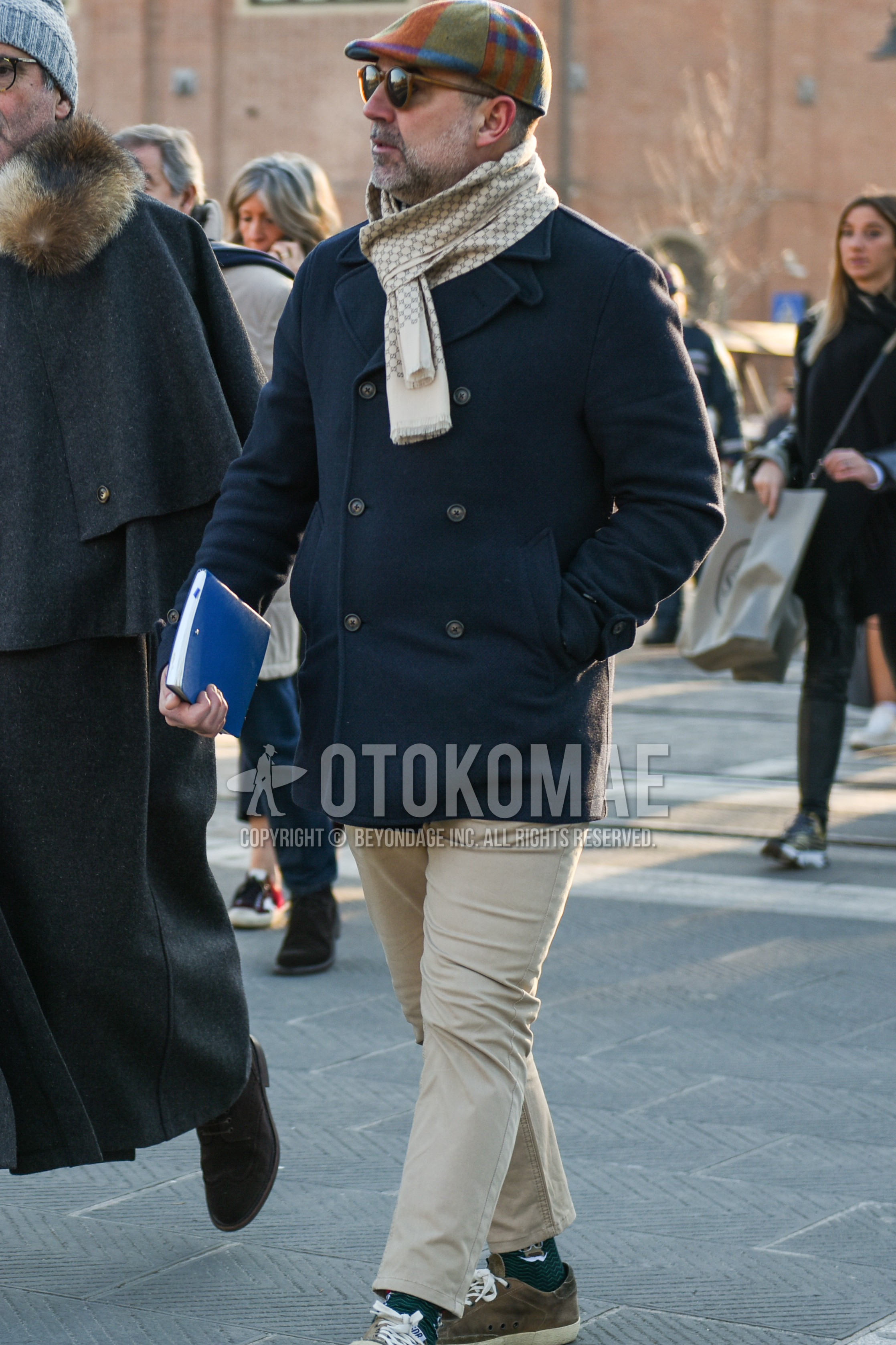 Men's autumn winter outfit with multi-color cap hunting cap, brown plain sunglasses, white scarf scarf, dark gray plain p coat, beige plain chinos, beige plain cropped pants, gray one point socks, brown low-cut sneakers.