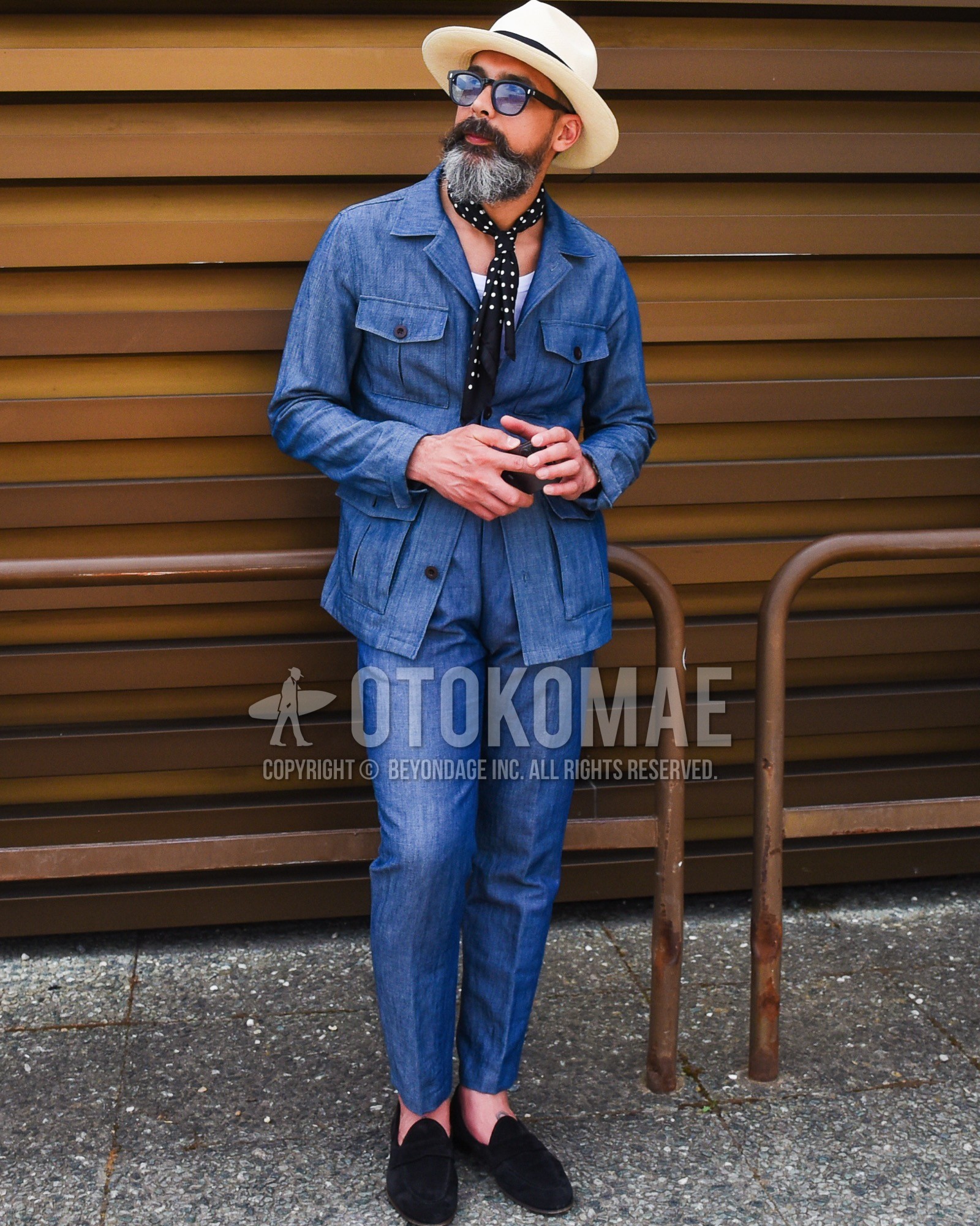 Men's spring summer outfit with white plain hat, black plain sunglasses, black dots bandana/neckerchief, white plain t-shirt, black coin loafers leather shoes, blue plain casual setup.