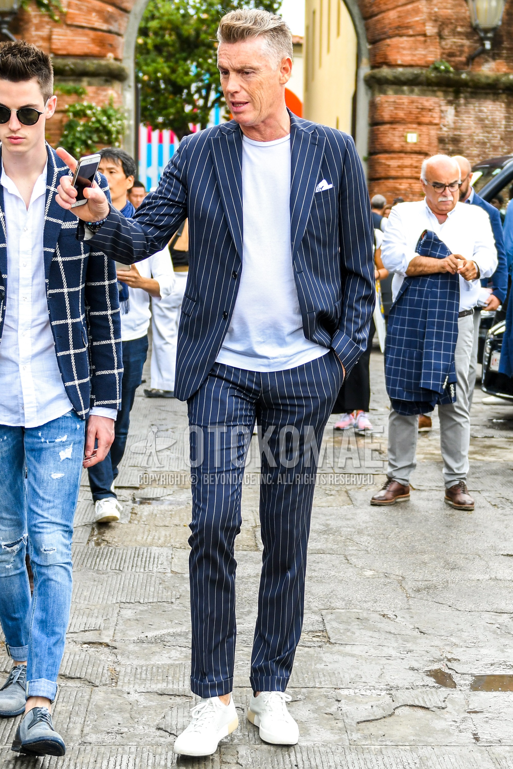 Men's spring summer autumn outfit with white plain t-shirt, white low-cut sneakers, navy stripes suit.